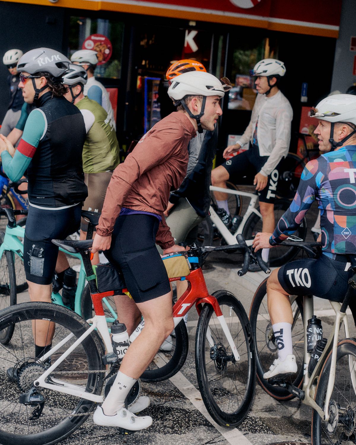 Cyclists in colorful jerseys and shorts gathered at Brand Summit 2024 event