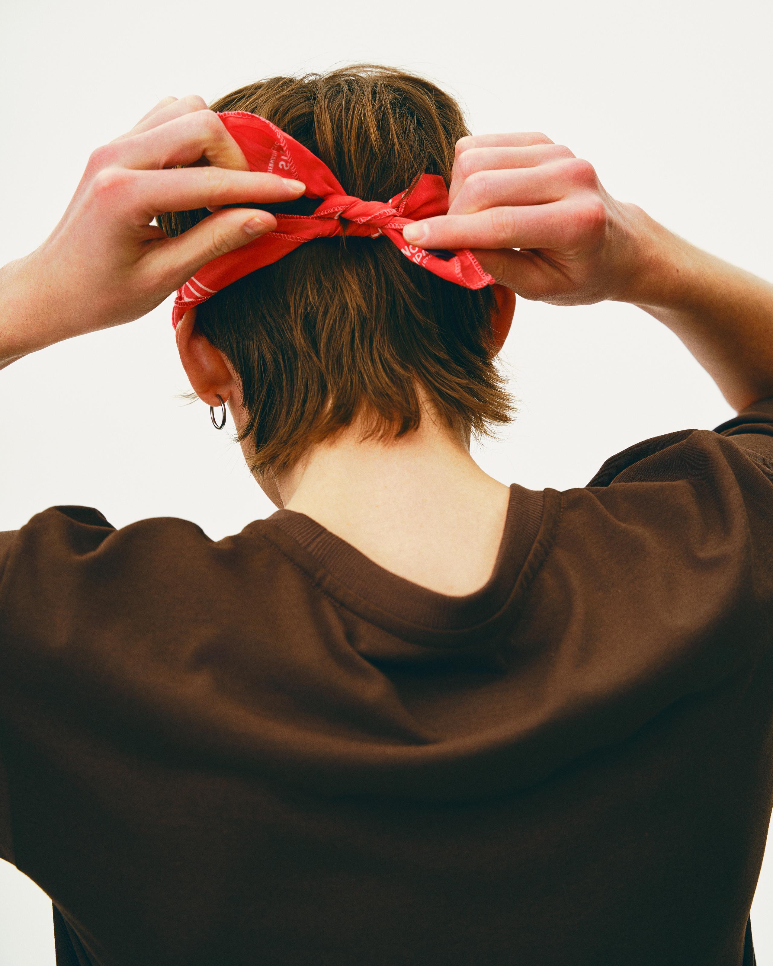 Red Off-Race bandana on model, rear view being tied in hair