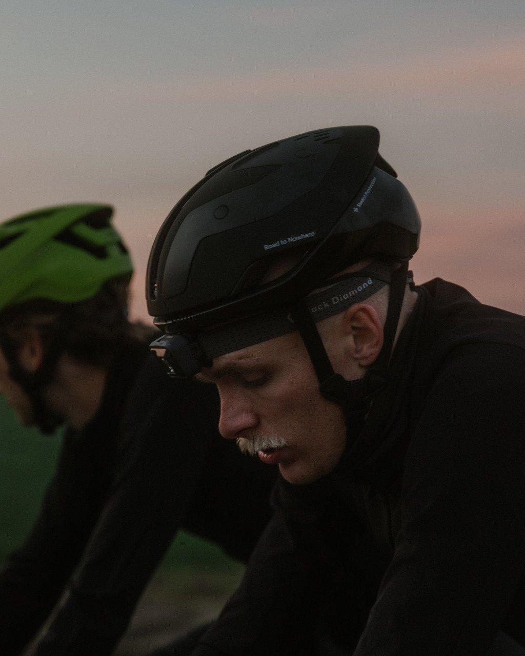 Models wearing cycling helmets during low light ride