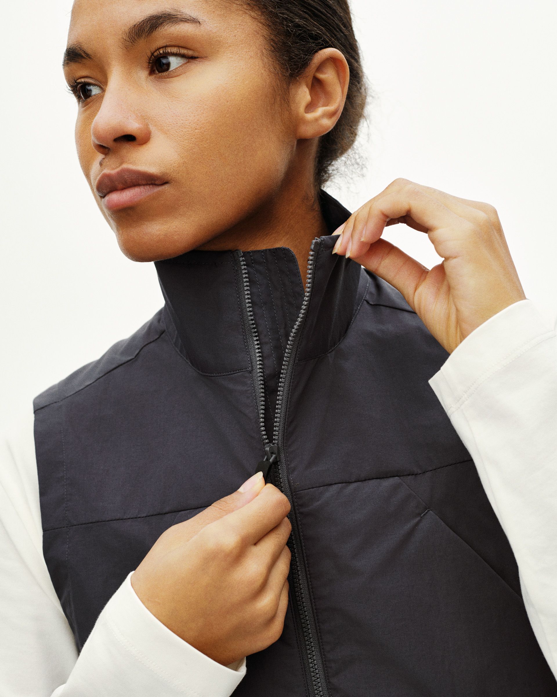Black Off-Race Utility vest on model with quilted panels and full zip closure