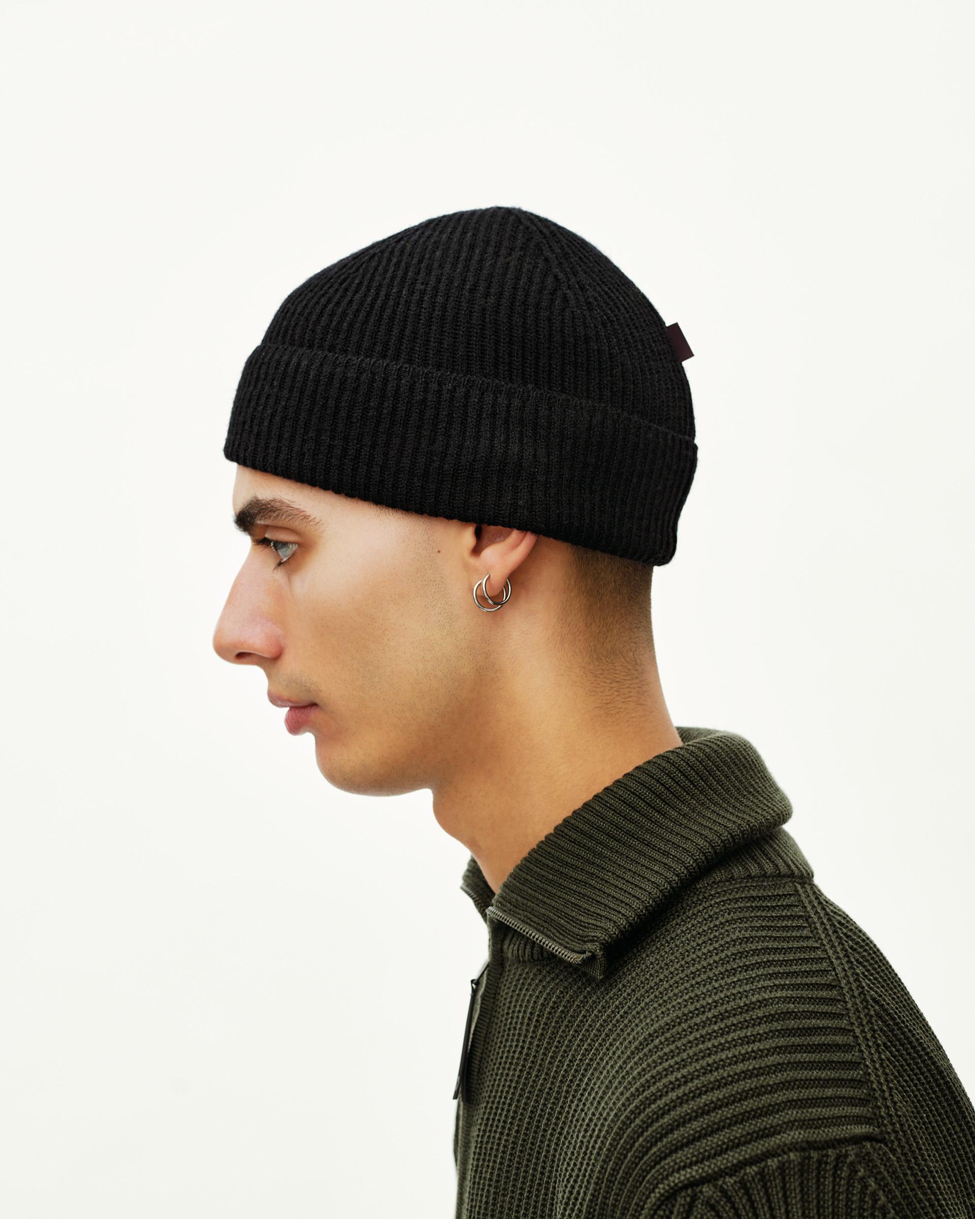 Black Off-Race Merino Knit Beanie on model, side view with ribbed cuff