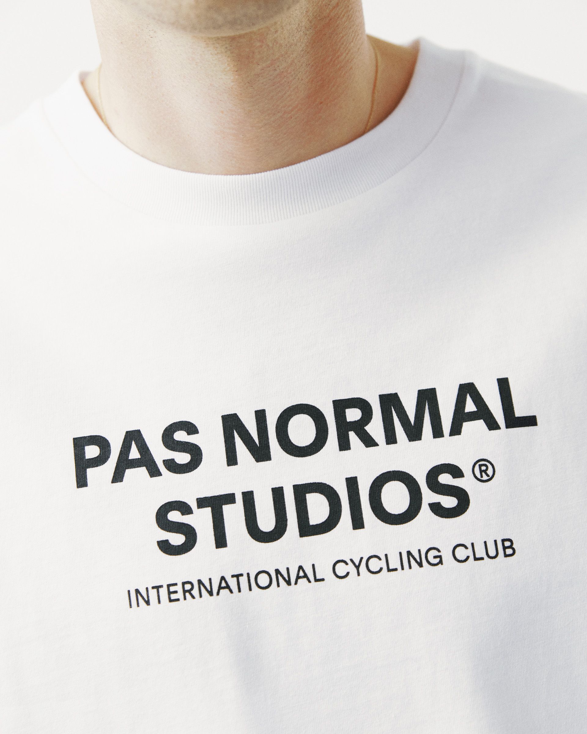 White Off-Race Logo T-shirt, chest detail on model with black International Cycling Club print