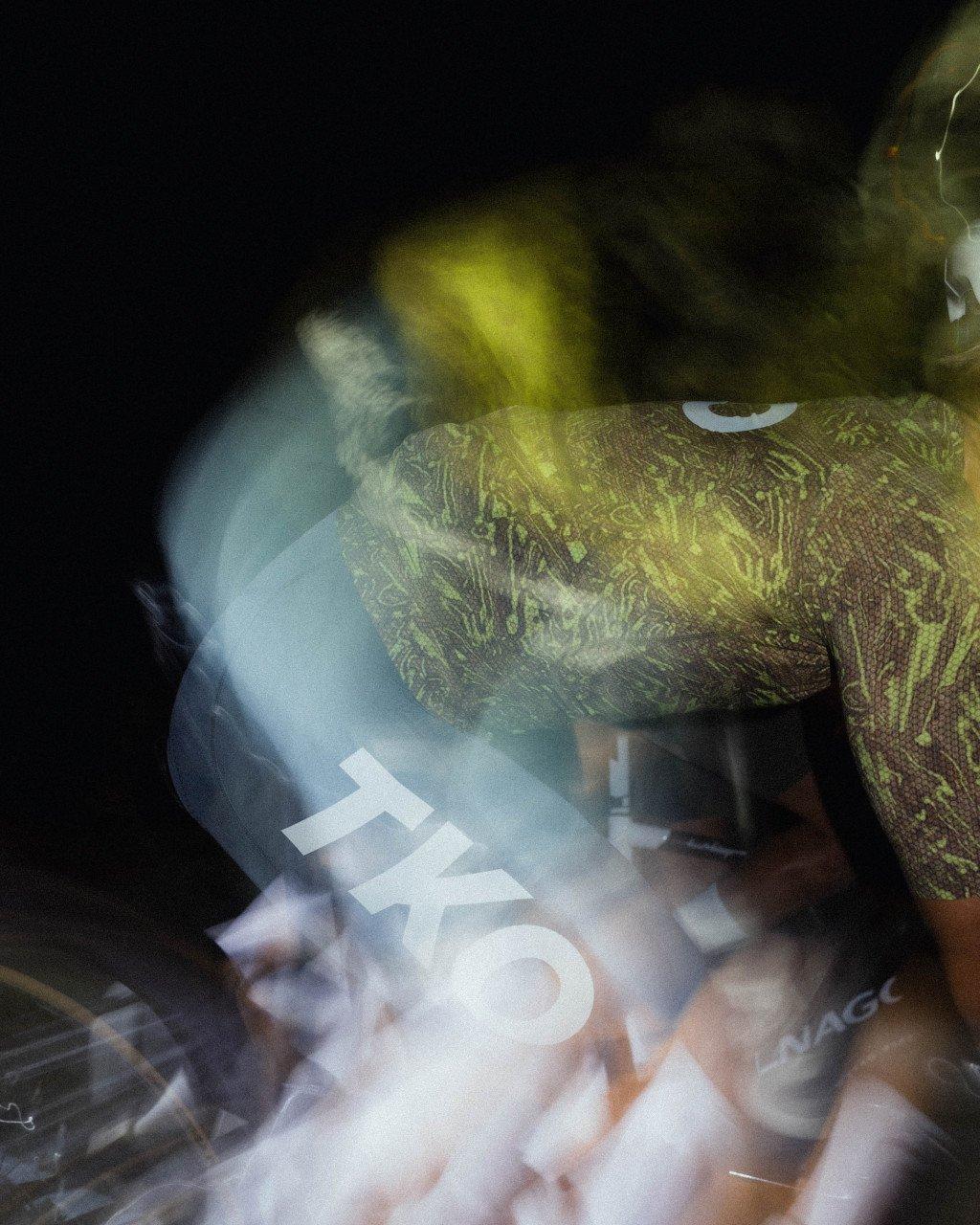 Model wearing green patterned jersey with motion blur effect