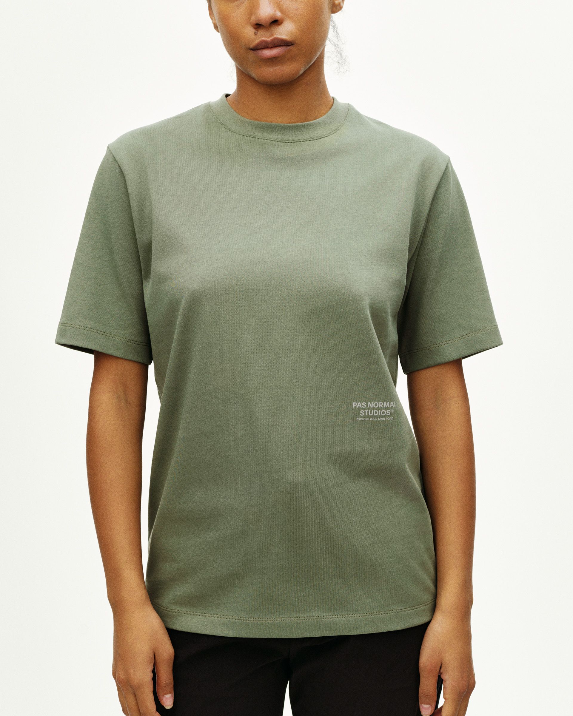 Green Off-Race t-shirt on model, front view with small logo print on lower right hem