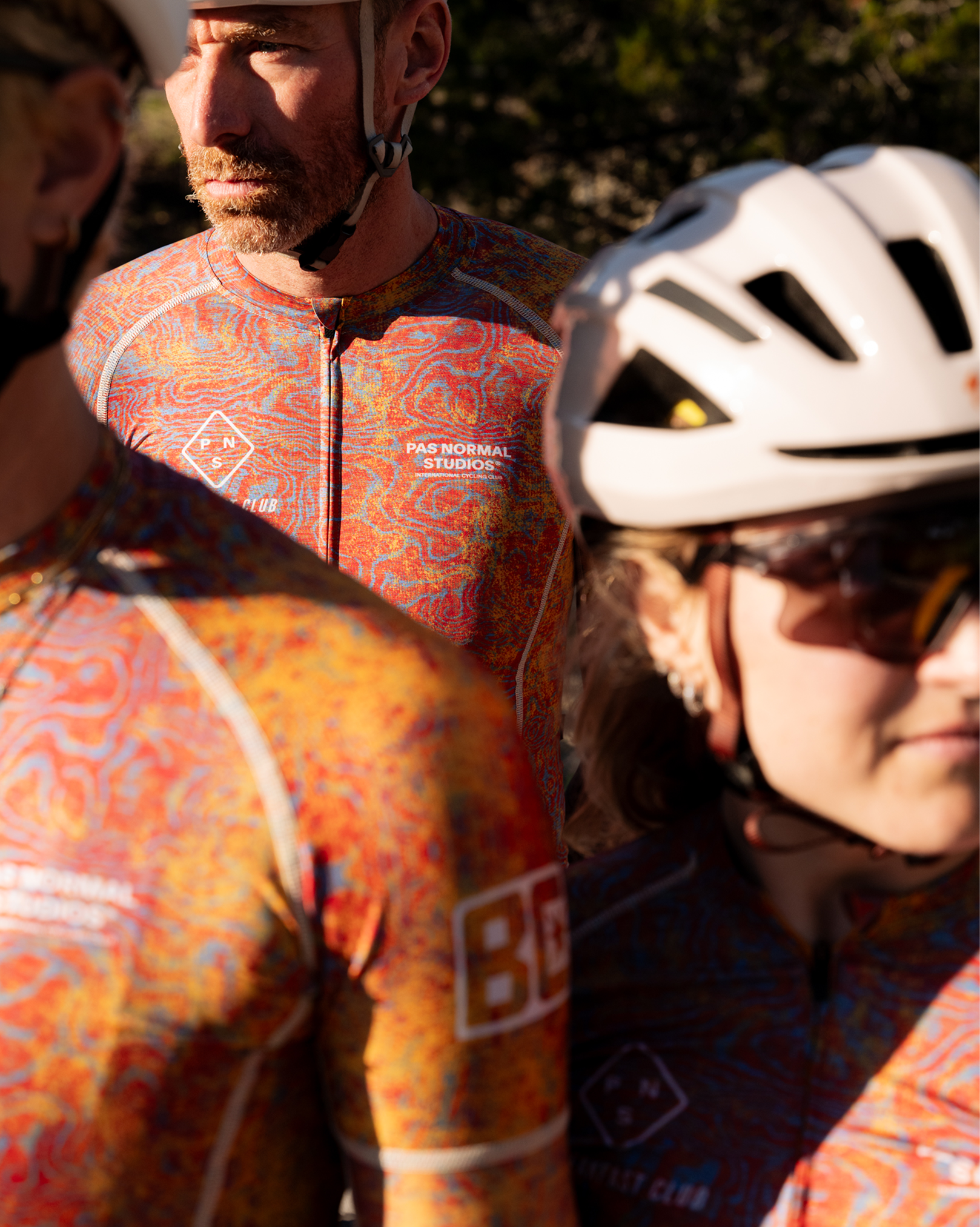 Model wearing orange paisley print cycling jersey and shorts from Breakfast Club collaboration