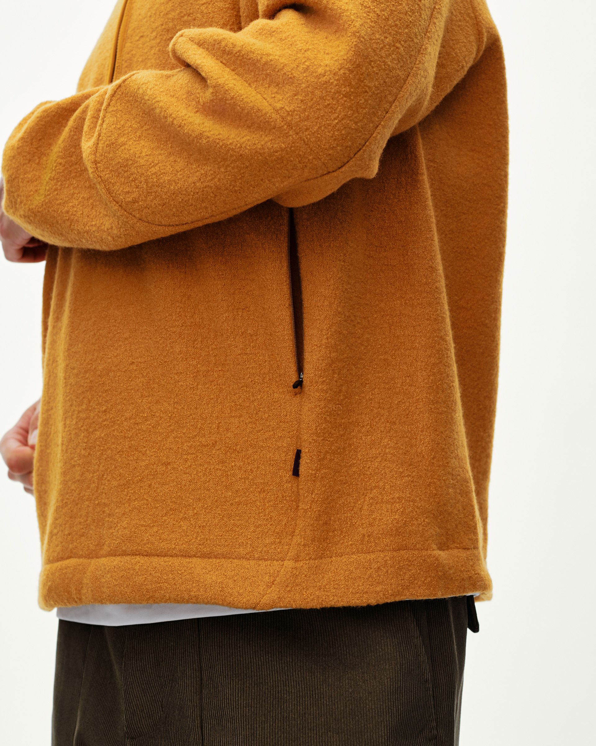 Ochre Off-Race Boiled Wool Half-Zip outerwear on model, side detail view with black zip pull