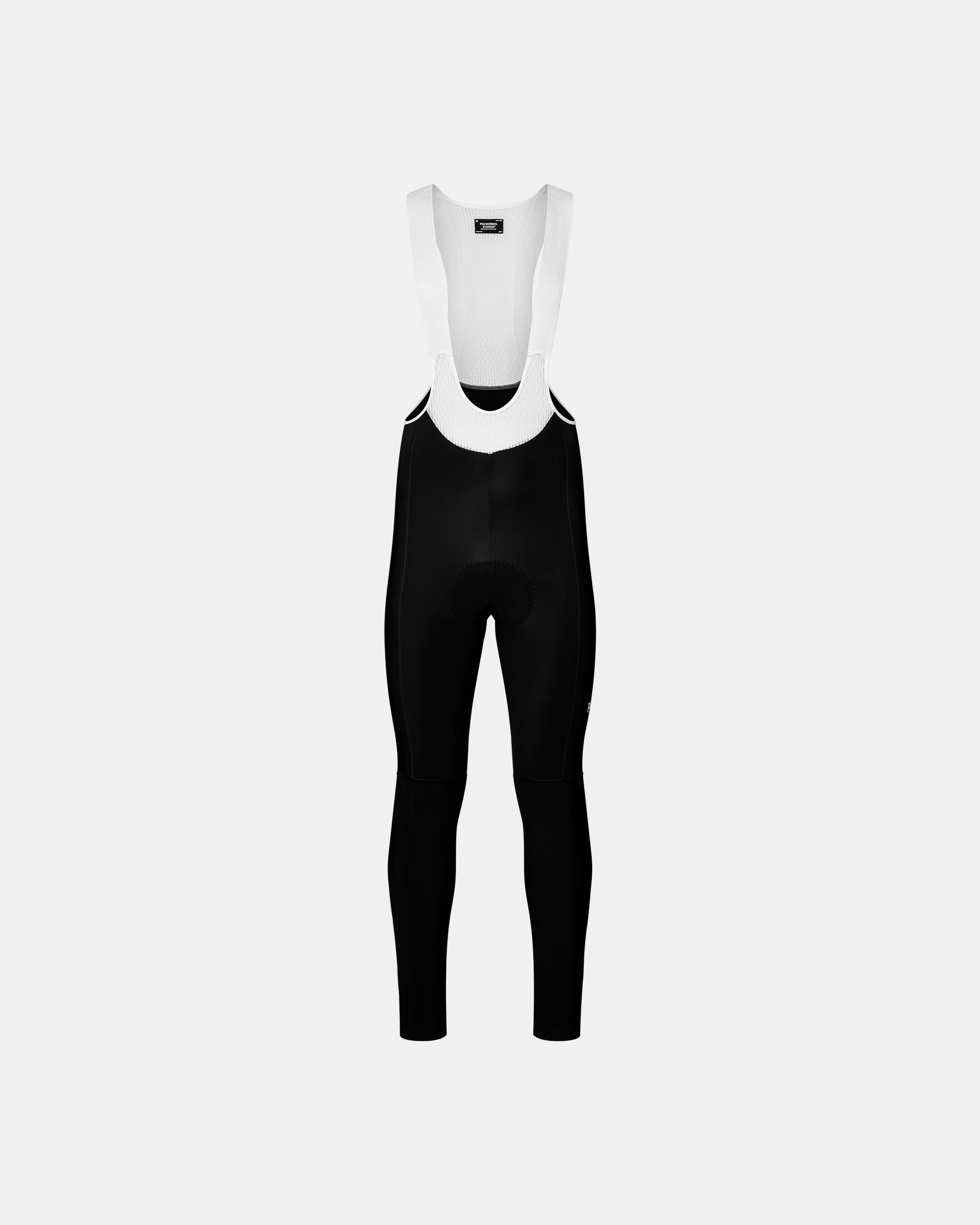 Black Mechanism cycling thermal long bibs, front flat lay with white mesh straps