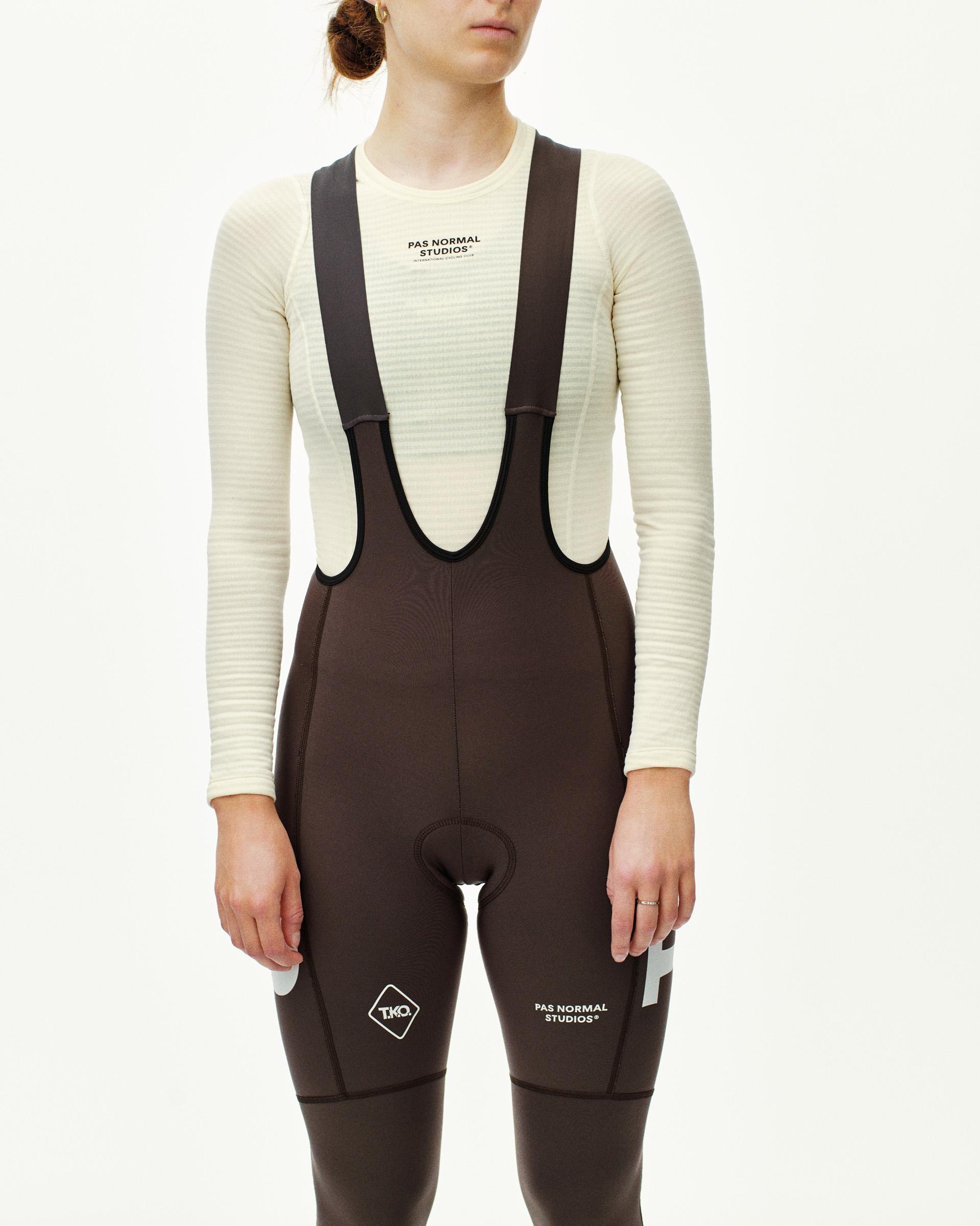 Dark Purple T.K.O. Essential Thermal Long cycling bibs on model, front view with large logo print on leg