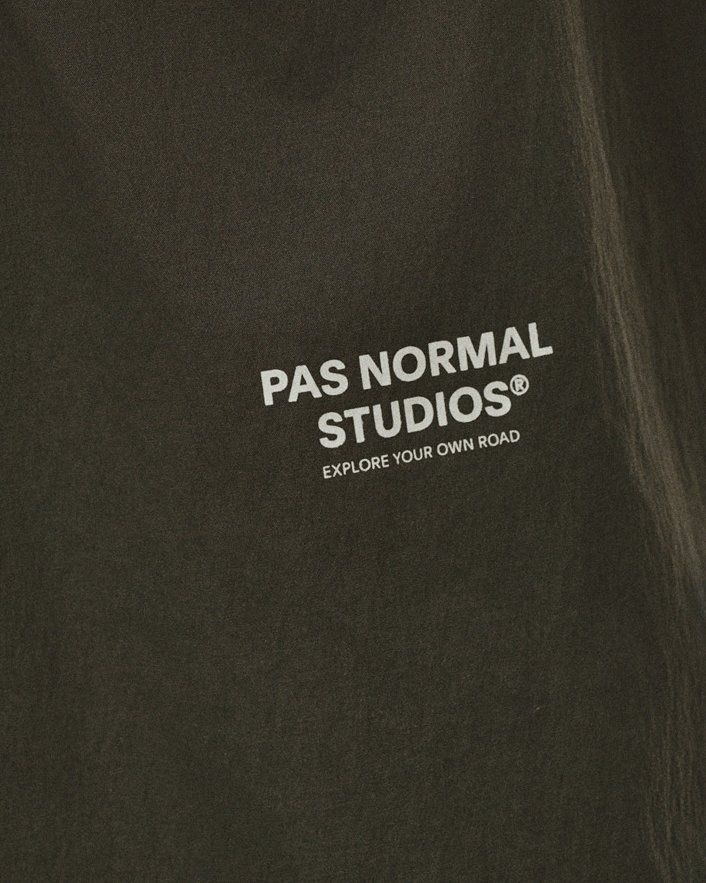 Dark Grey Off-Race Light Tech Shirt, detail view with white chest logo and tagline
