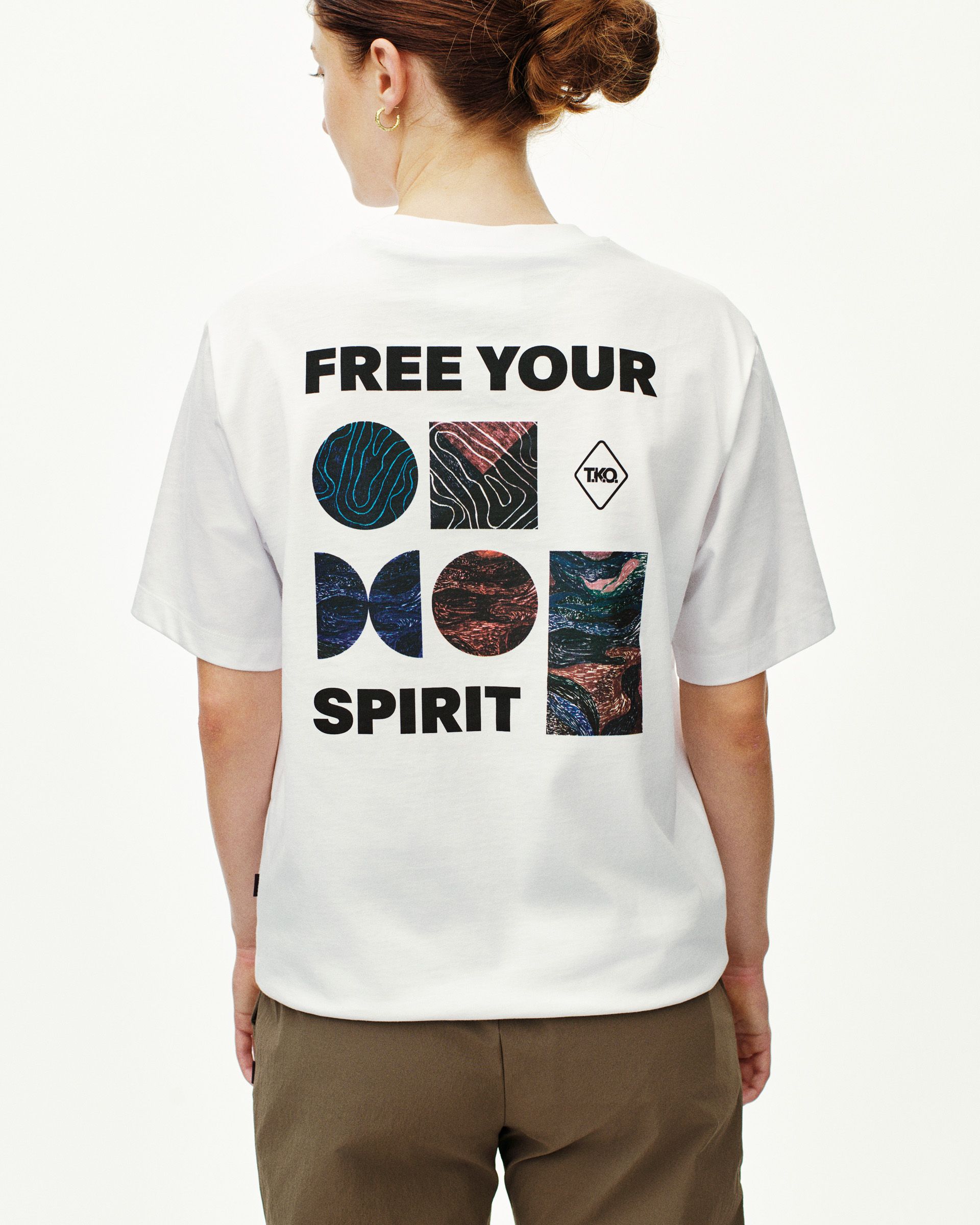 White T.K.O. Off-Race Graphic T-shirt on model, rear view with multicolour abstract print and Free Your Spirit text