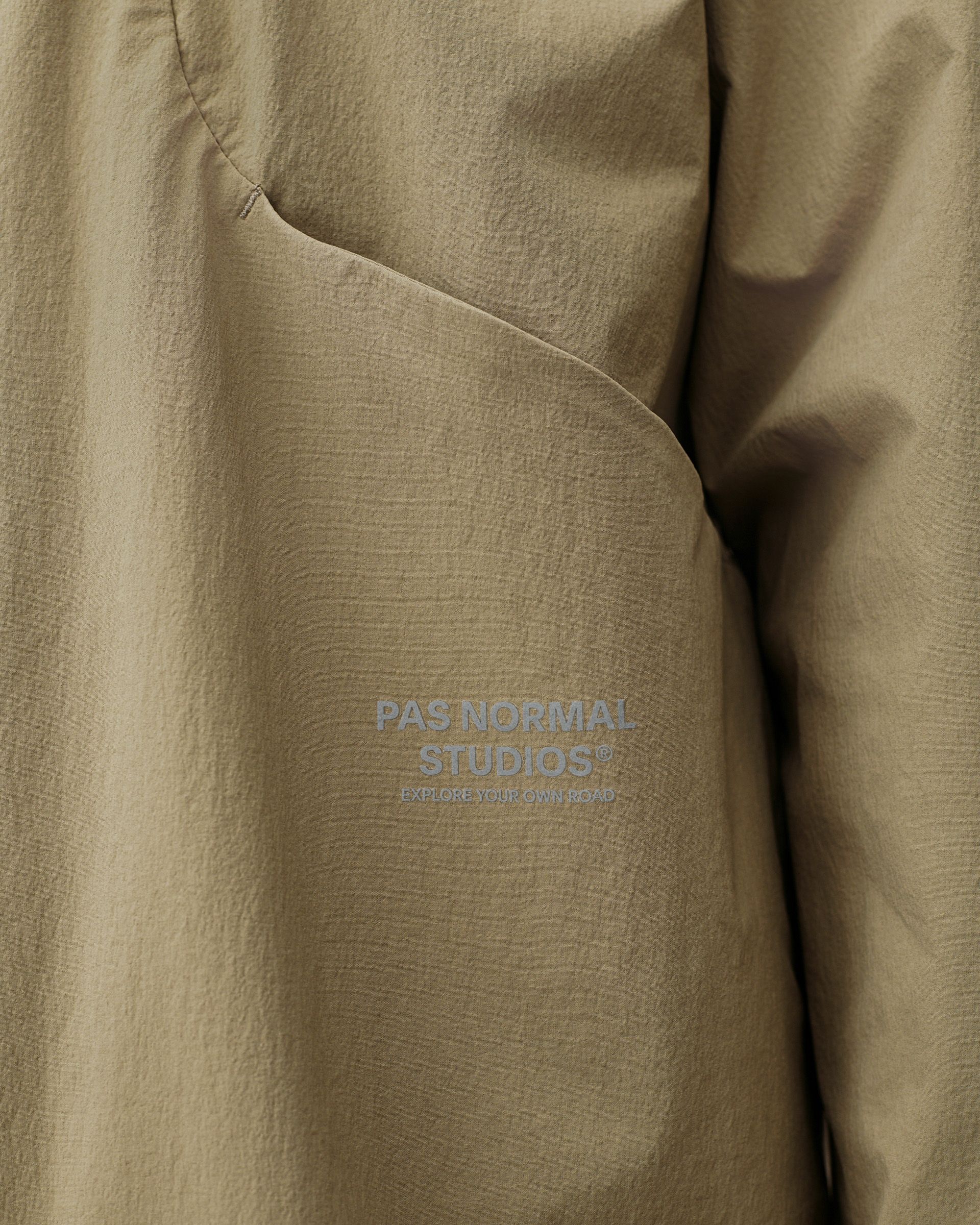 Dusty Earth khaki Off-Race Tech Overshirt outerwear, detail view of chest pocket with tonal logo print