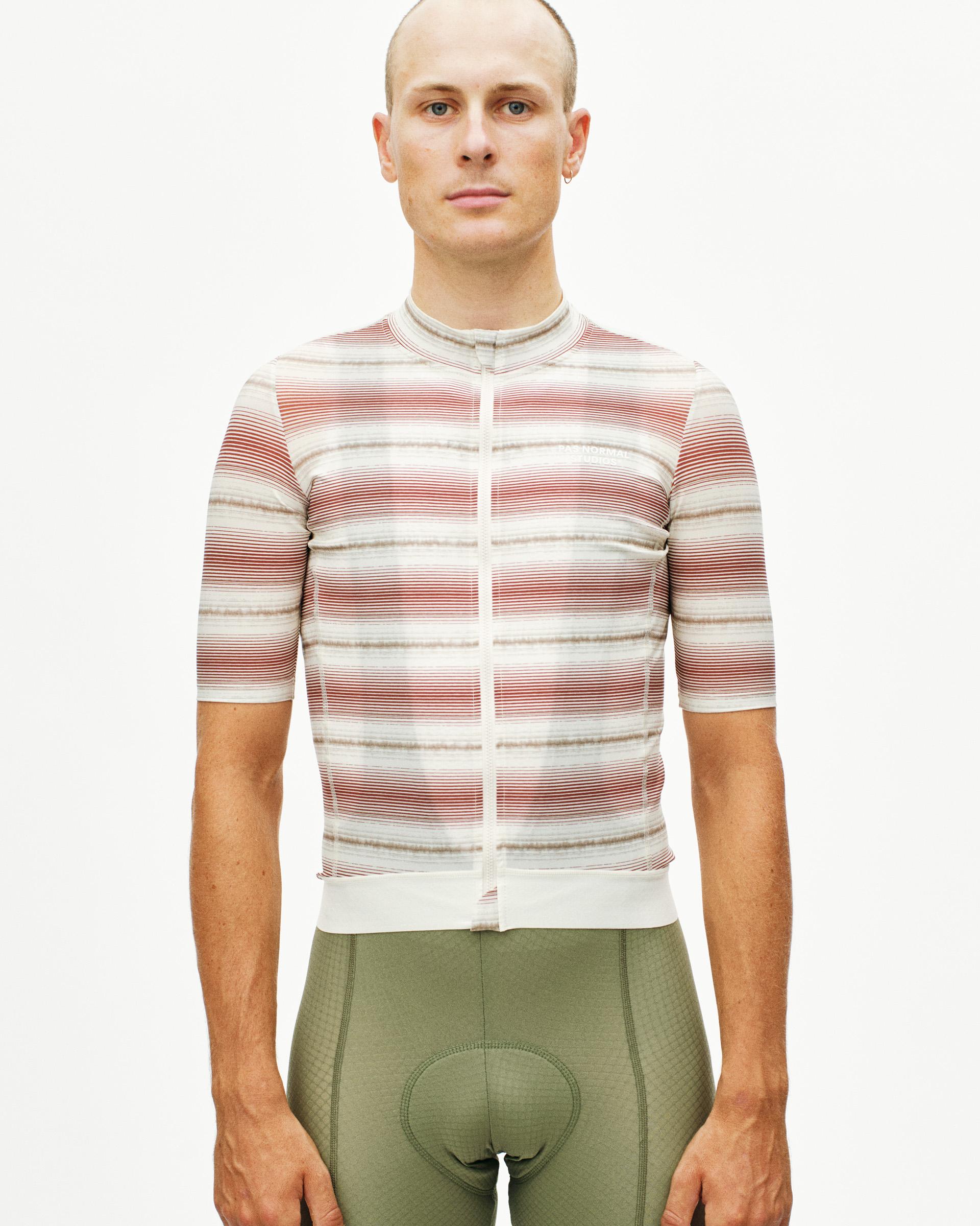 White Essential cycling jersey on model with horizontal striped pattern