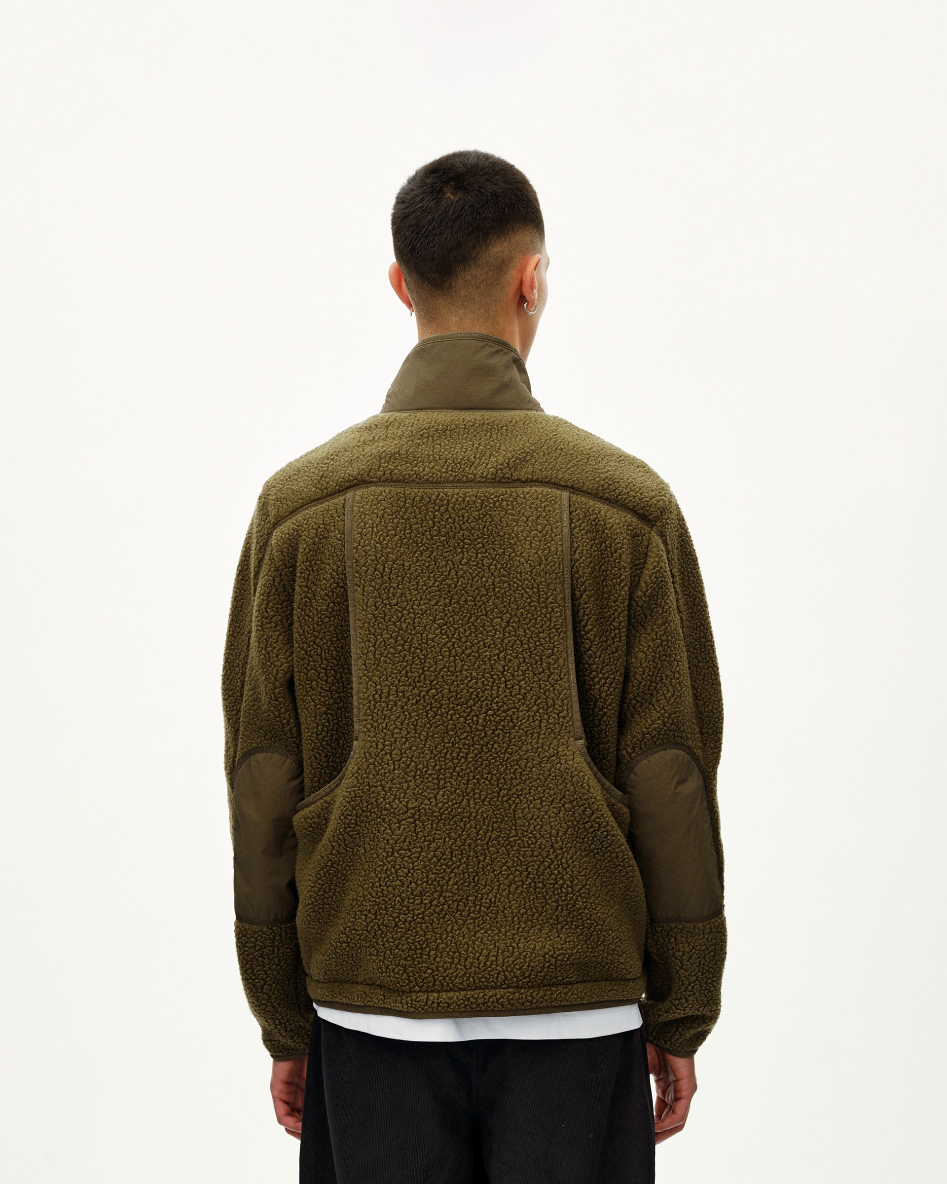 Deep Olive Off-Race Pile Fleece jacket on model, rear view with contrast nylon panels and back pocket