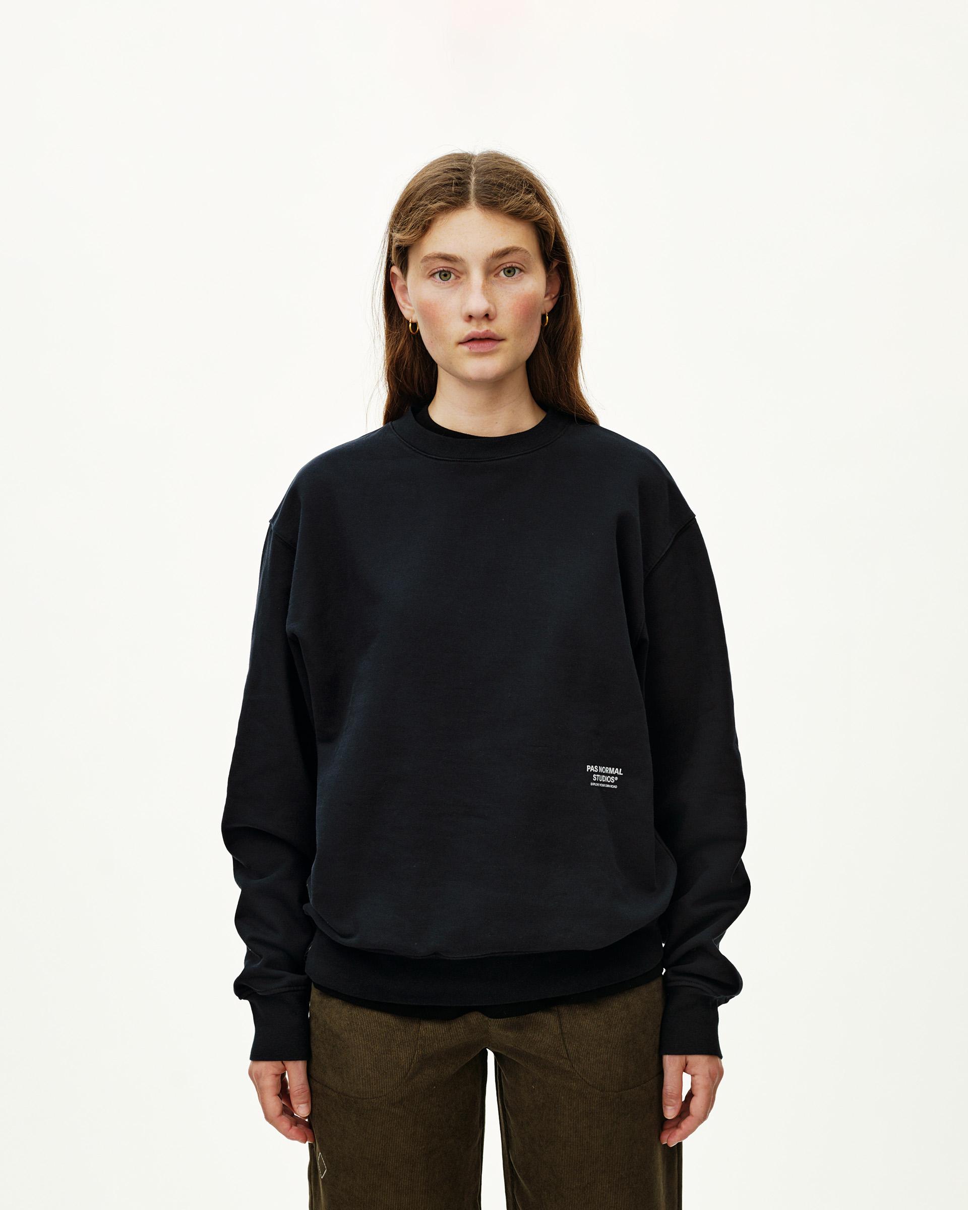 Black Off-Race sweatshirt on model, front view with small chest logo print