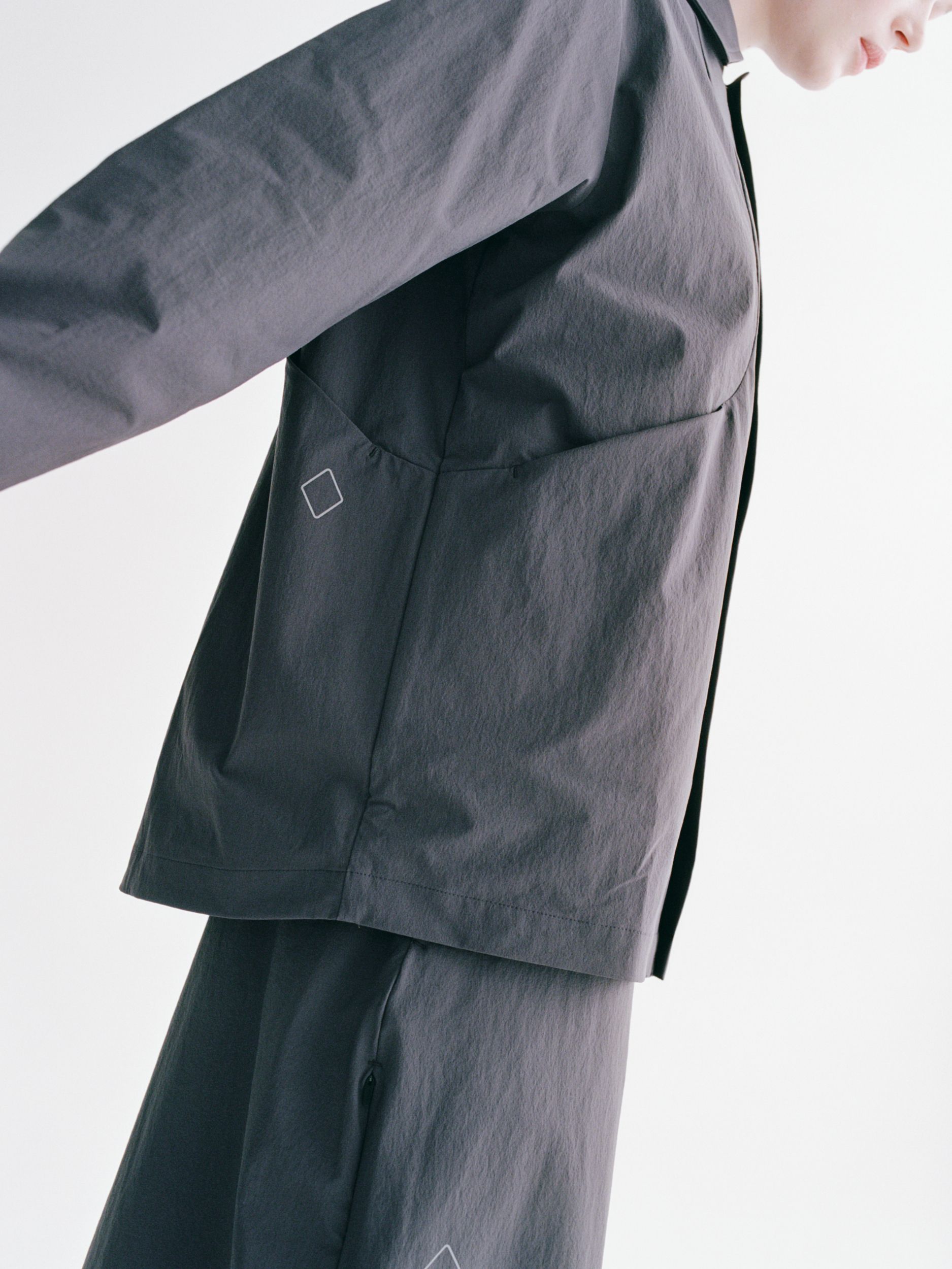 Grey Off-Race Tech Overshirt on model showing chest pocket with logo detail