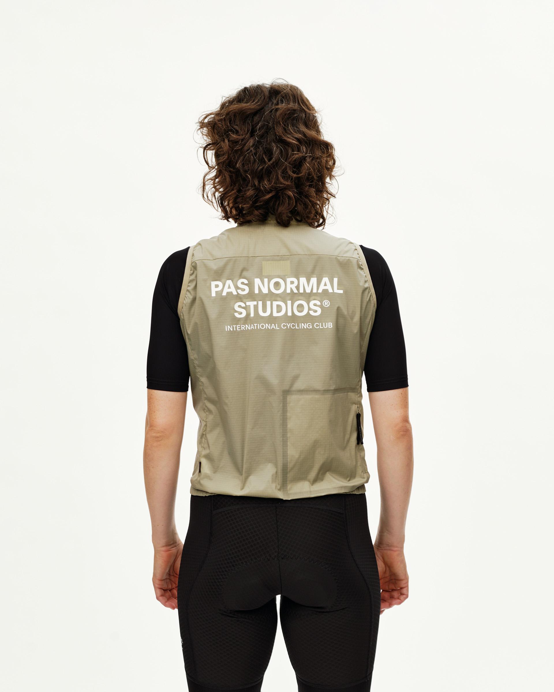 Grey Sage Essential Insulated cycling gilet on model, rear view with white back logo print