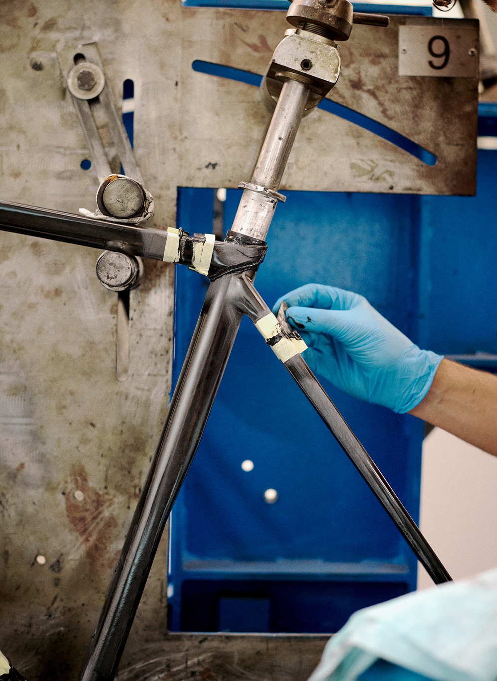 Carbon frame tubes being assembled by hand in Italian bicycle manufacturing facility