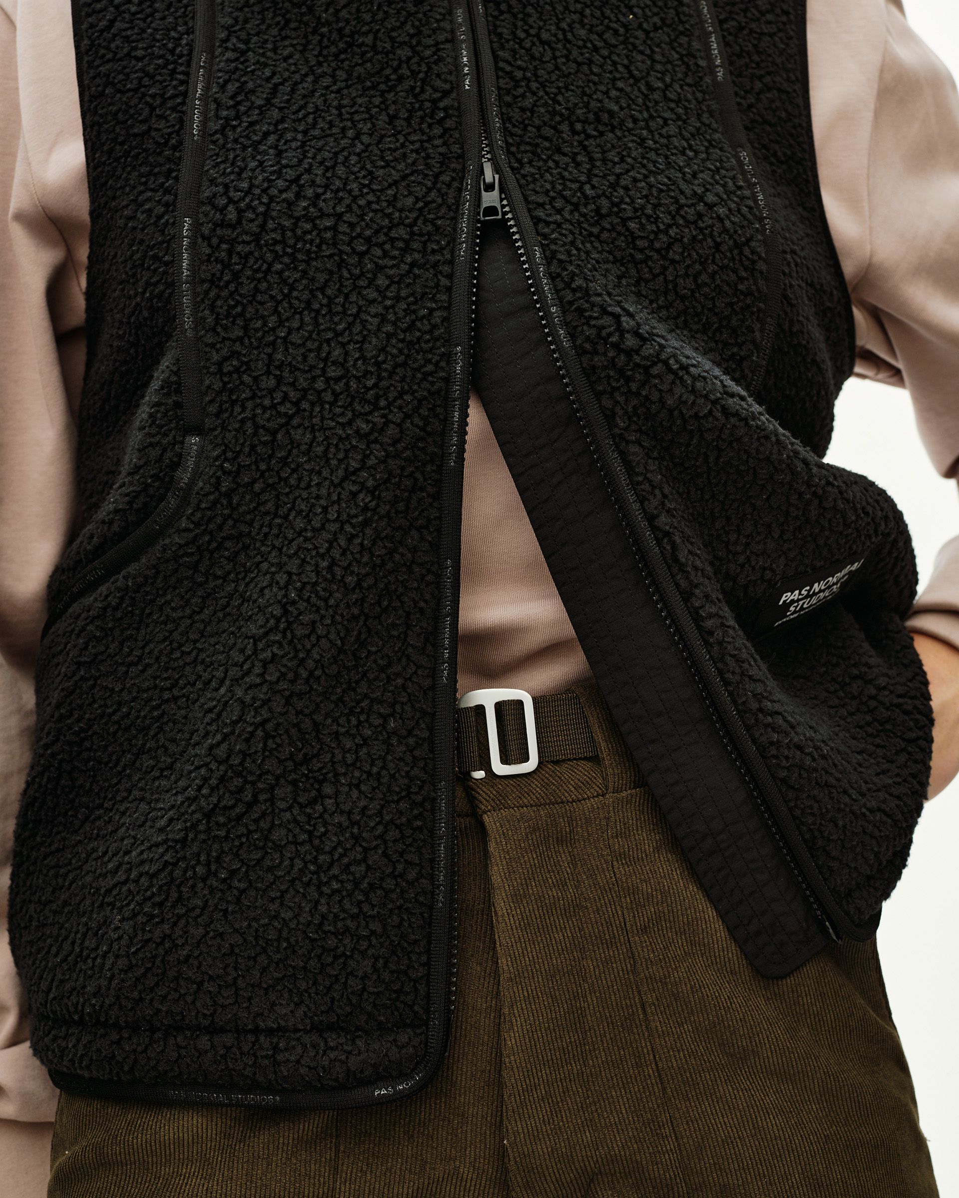 Black Off-Race Pile Fleece vest on model, front detail view with open zip and sherpa texture