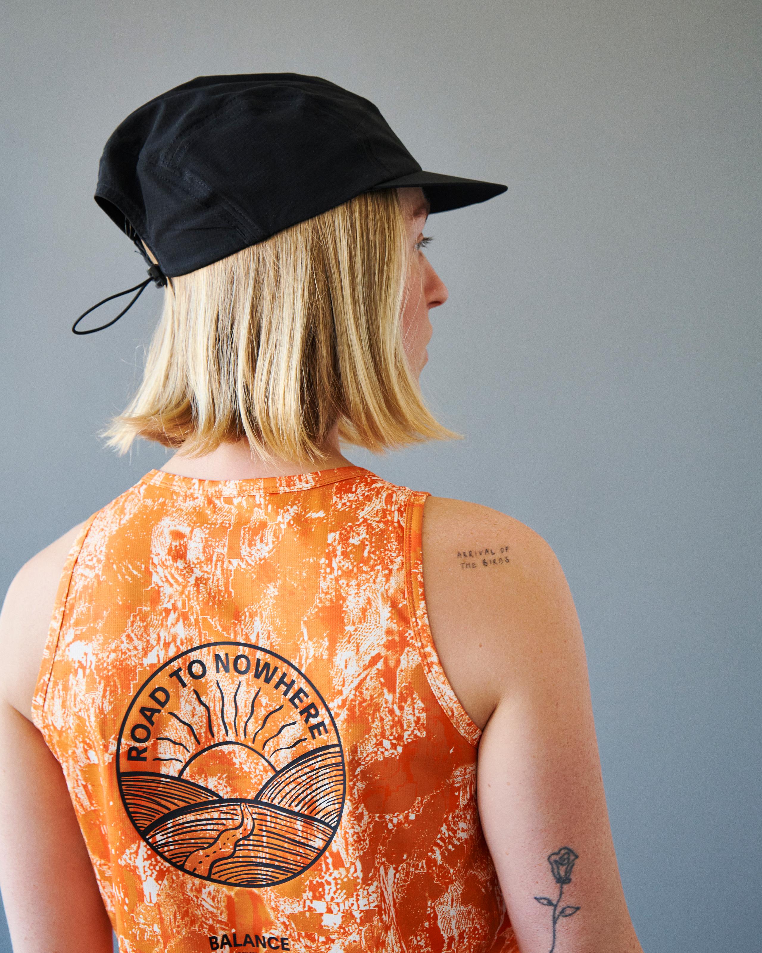 Orange Balance singlet on model, rear view with Road To Nowhere circular back print