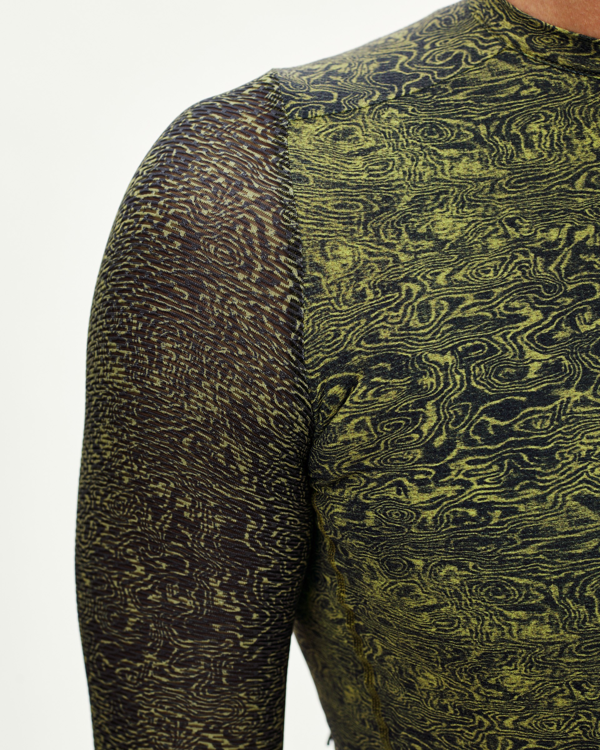 Dark Lime Essential long sleeve cycling jersey, shoulder detail on model with all-over swirl print