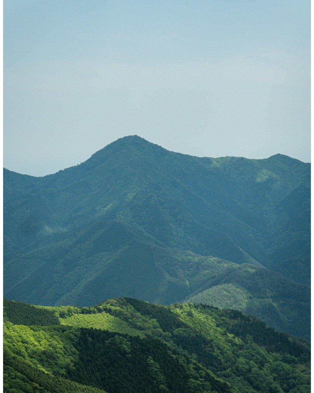 Rolling green mountains under hazy sky in Shikoku