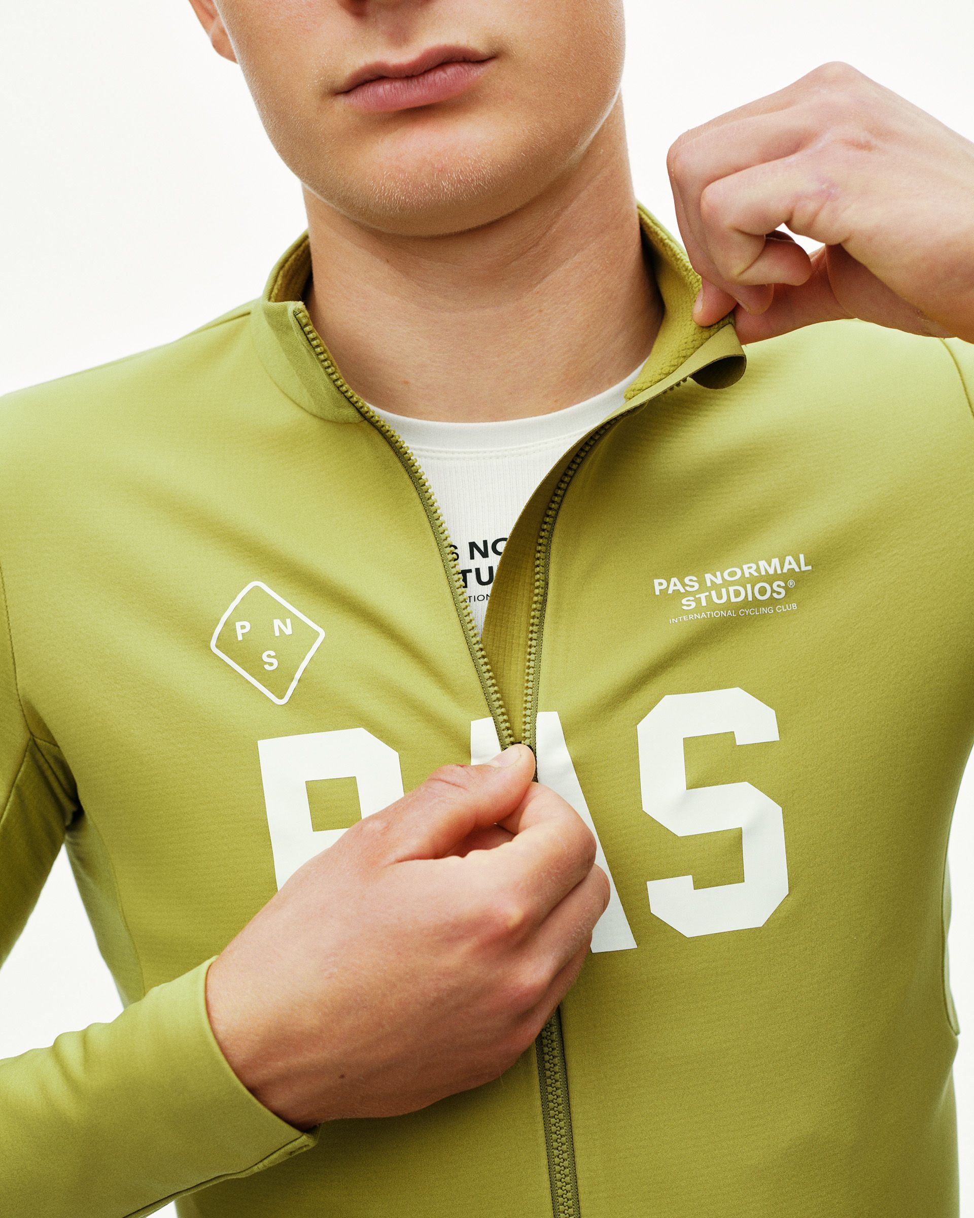 Dark Lime green PAS Mechanism Thermal Long Sleeve cycling jersey 2.0, front detail on model with large white chest print