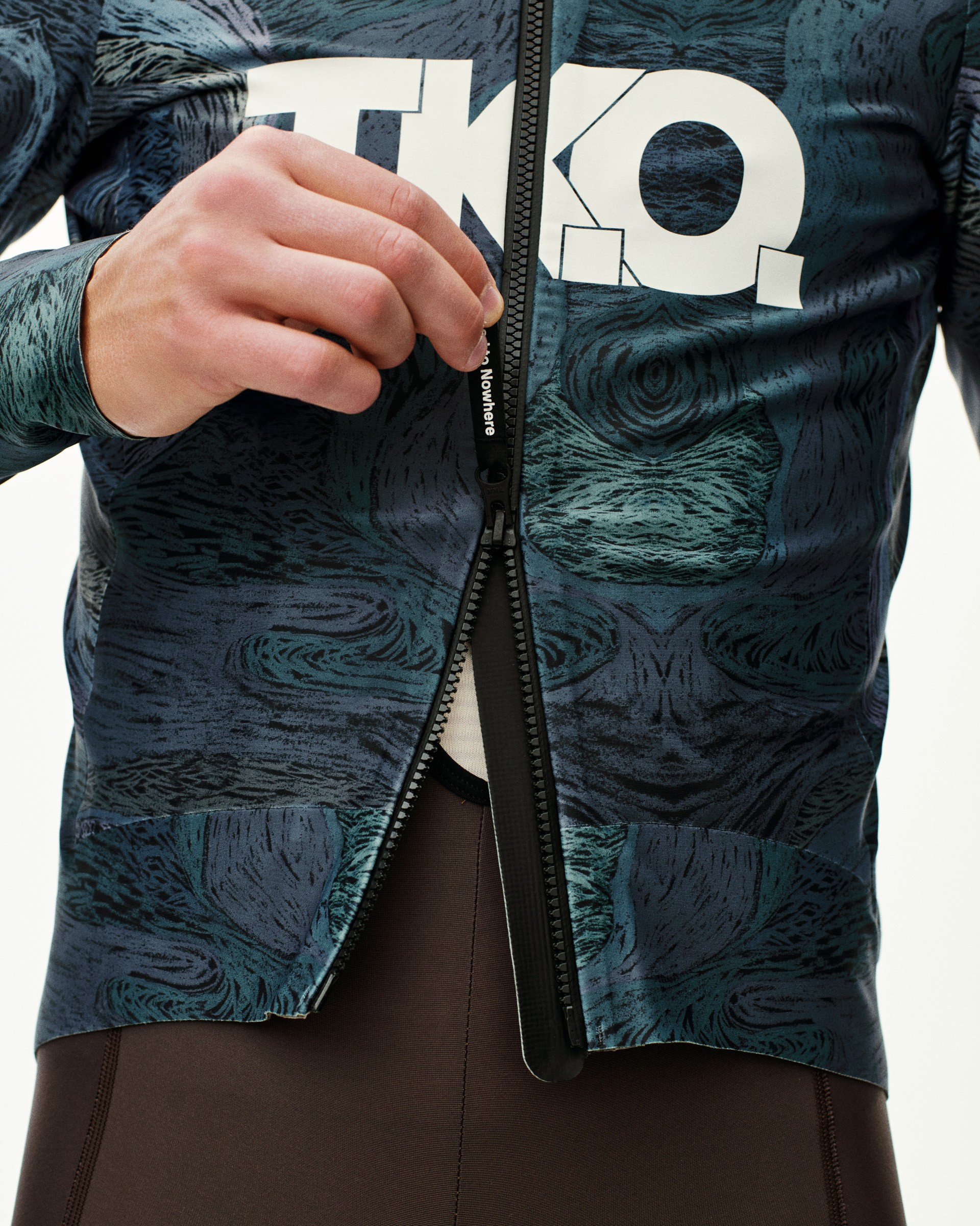 Dark Multi T.K.O. Mechanism Thermal cycling jacket, front detail on model with full zip open and allover print