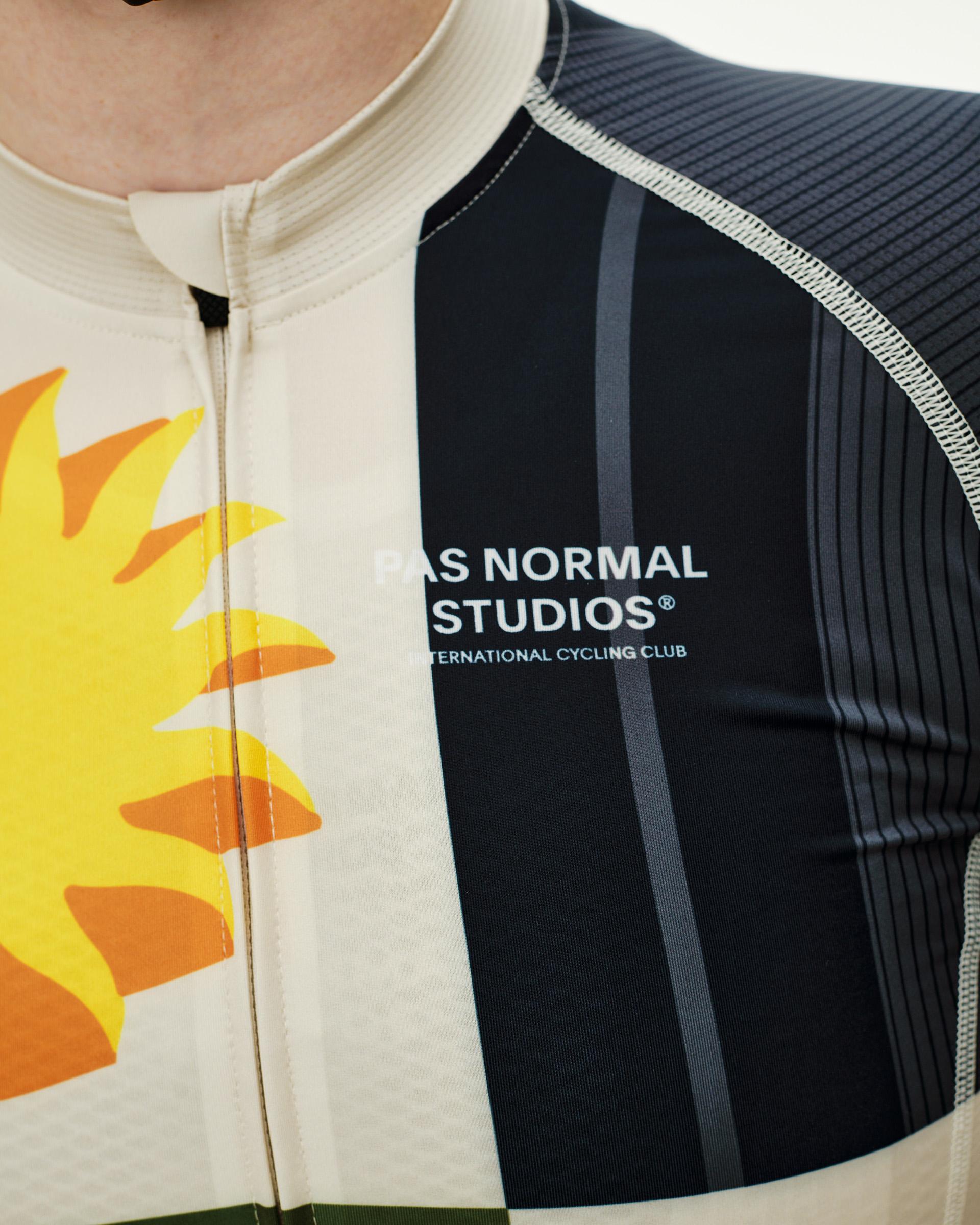 International Sand Mechanism cycling jersey, front detail on model with sun graphic and navy chest panel