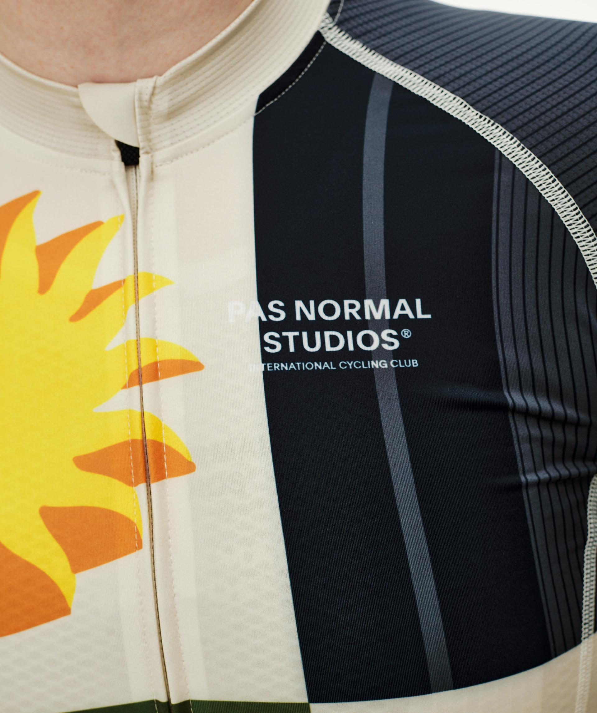 International Sand Mechanism cycling jersey, front detail on model with sun graphic and navy chest panel