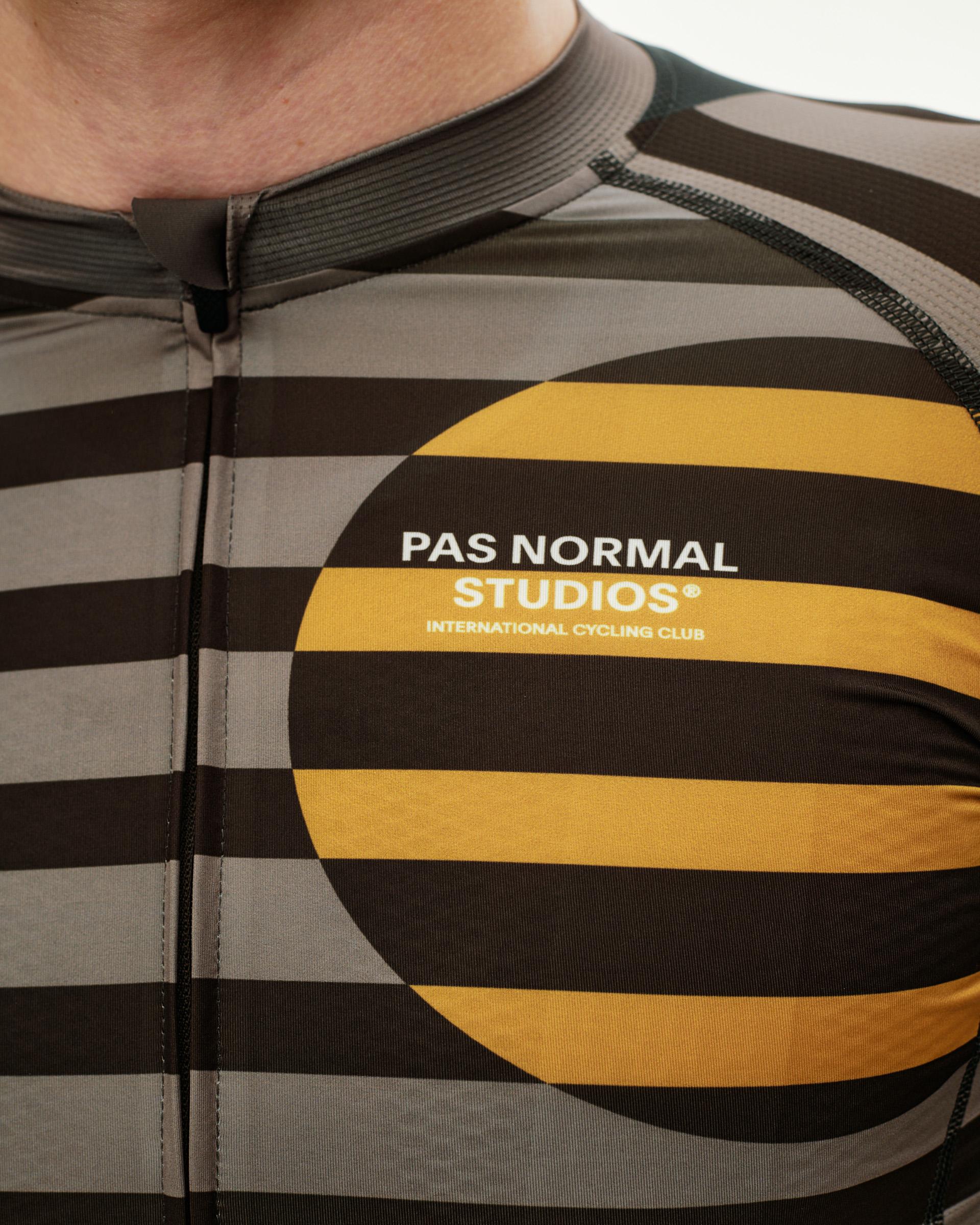 International Earth brown Mechanism cycling jersey, front detail on model with stripe and circle print