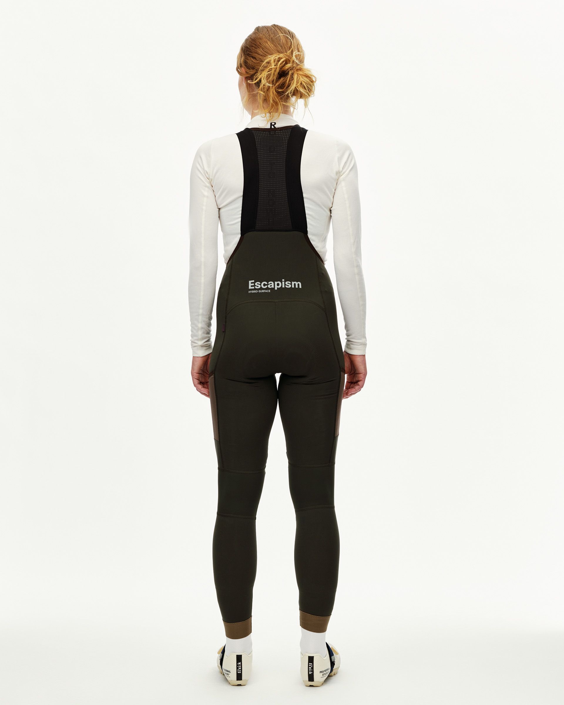 Dark Olive Escapism Long Cargo cycling bibs on model, rear view with mesh back strap and contrast panel