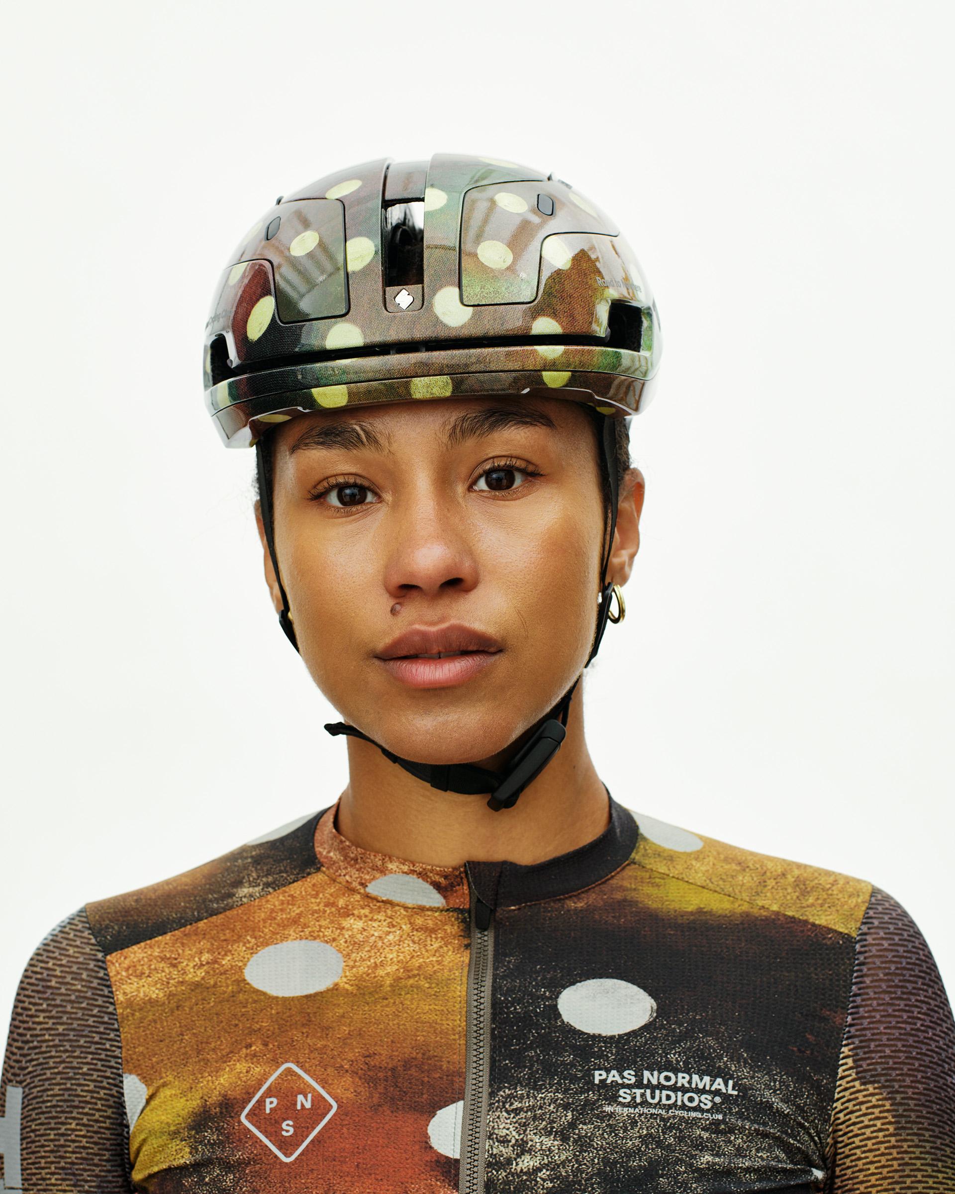Brown T.K.O. Falconer Aero 2Vi cycling helmet on model with camouflage pattern and vents