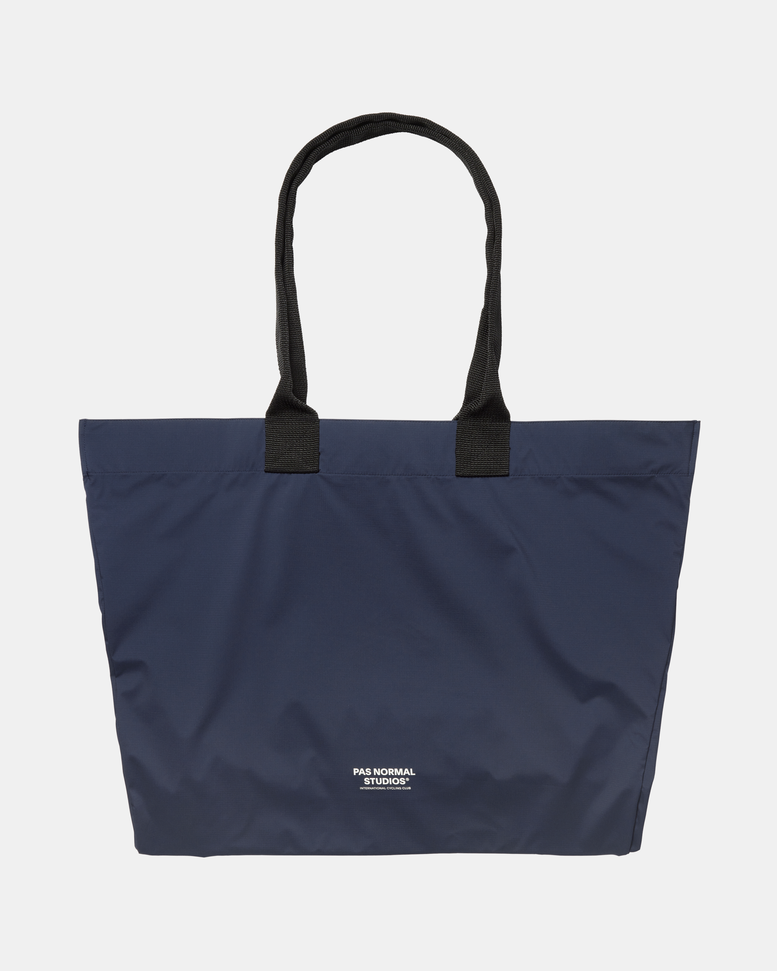 Navy Logo Shield tote bag, front view with black handles and white logo print