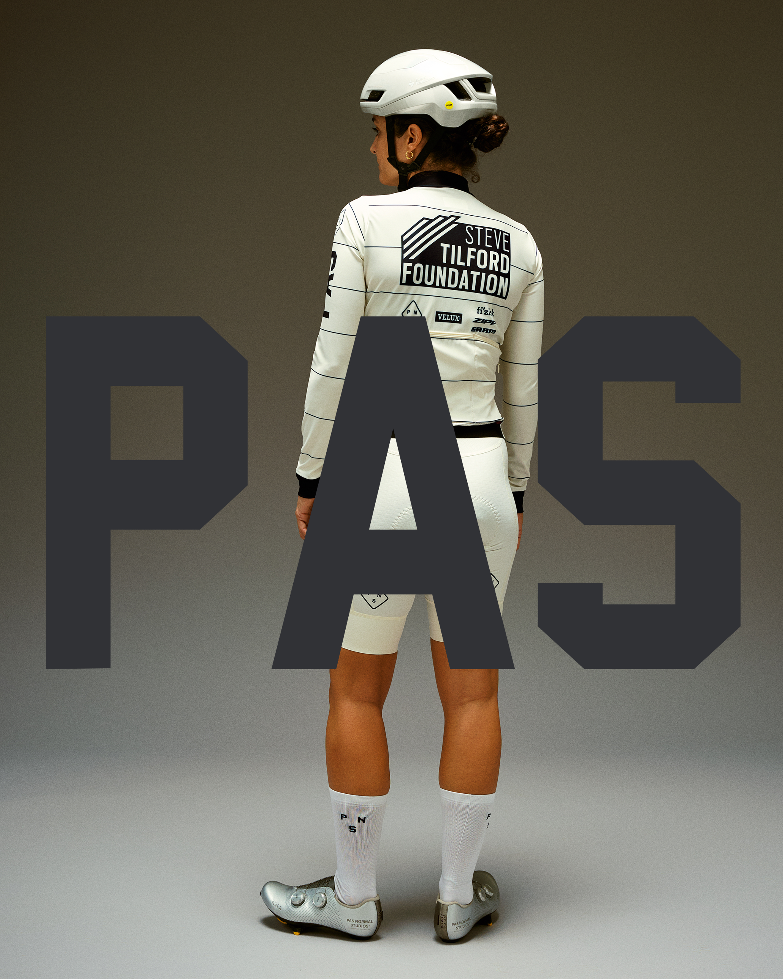 Model wearing Women's PAS Steve Tilford Foundation long-sleeve jersey and bib shorts in white, shown from behind