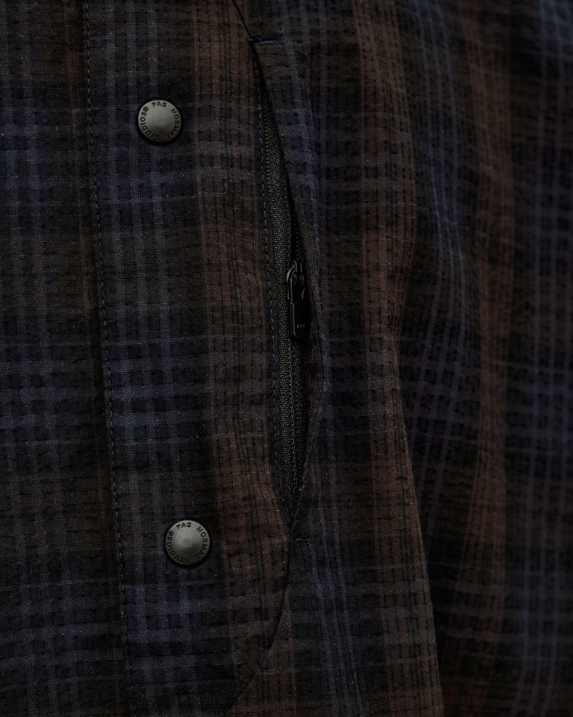 Dark Navy Off-Race Seersucker Shirt, detail view of open zip chest pocket and branded snap buttons