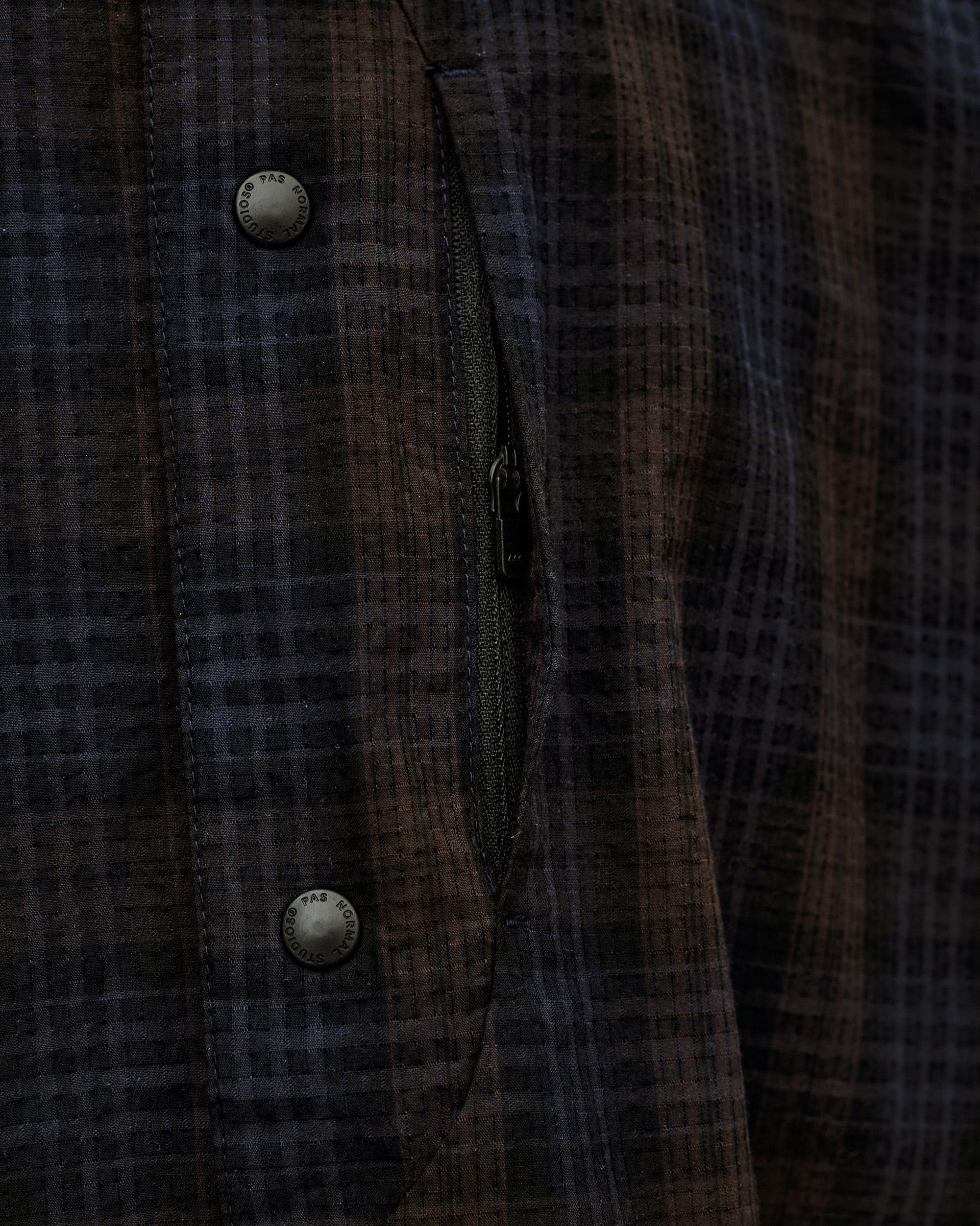 Dark Navy Off-Race Seersucker Shirt, detail view of open zip chest pocket and branded snap buttons