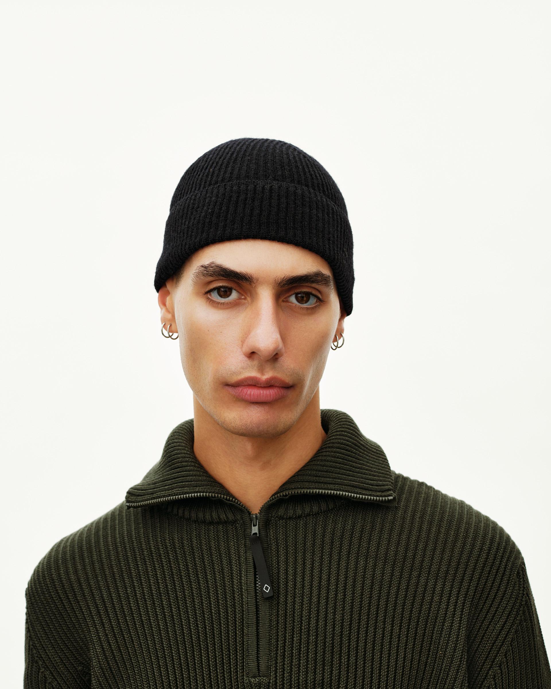 Black Off-Race Merino Knit Beanie on model, front view with ribbed knit texture