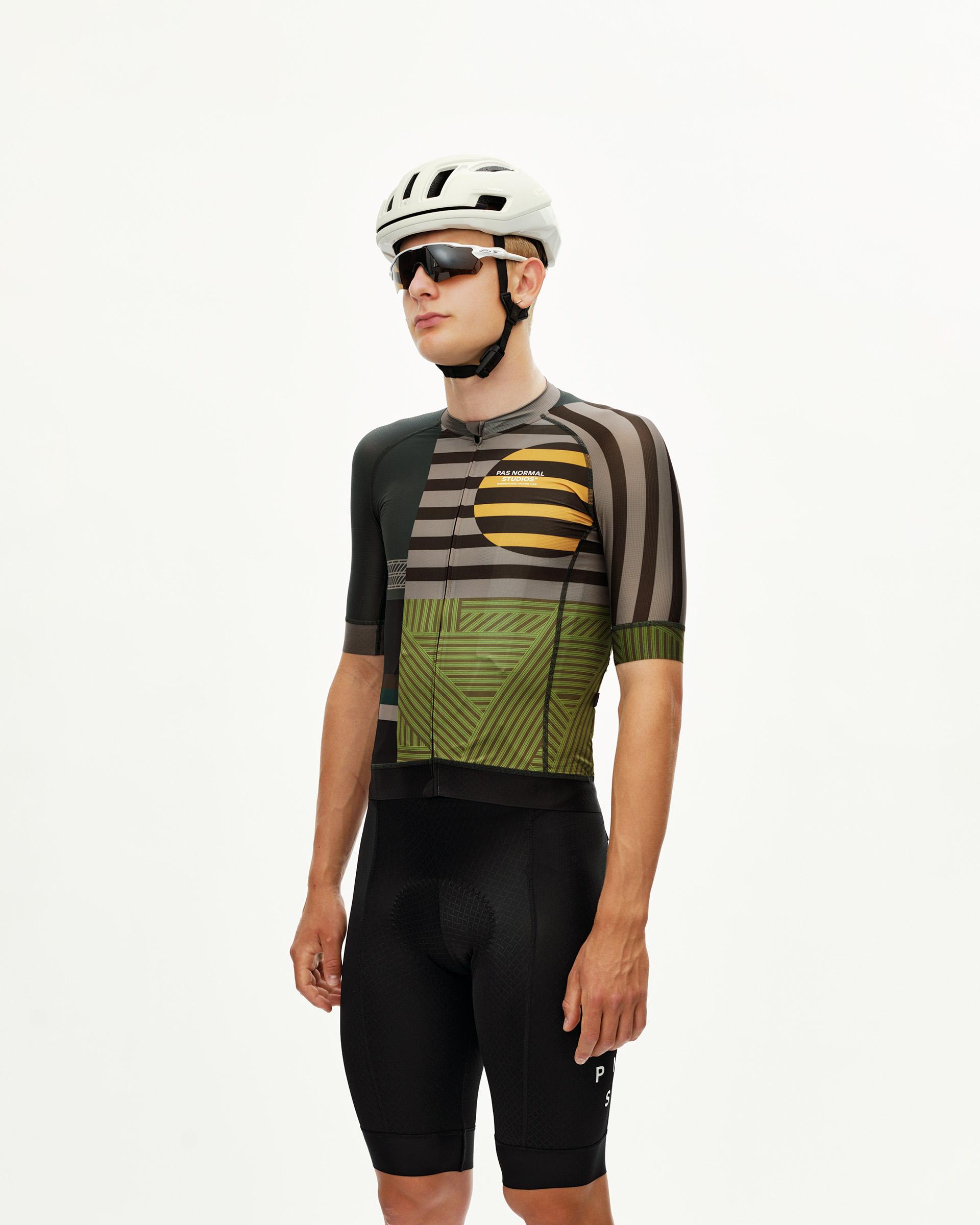 International Earth Mechanism cycling jersey on model, three-quarter front view with geometric stripe print