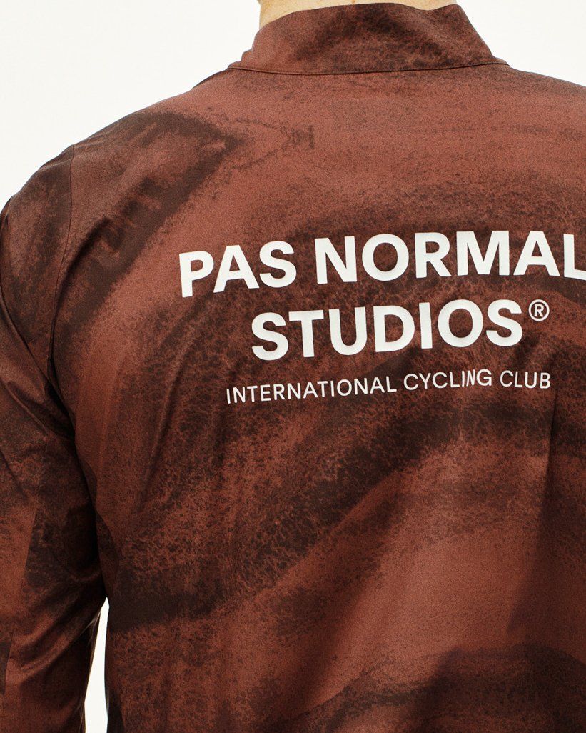Light brown Mechanism Stow Away jacket, rear view on model with white brand logo