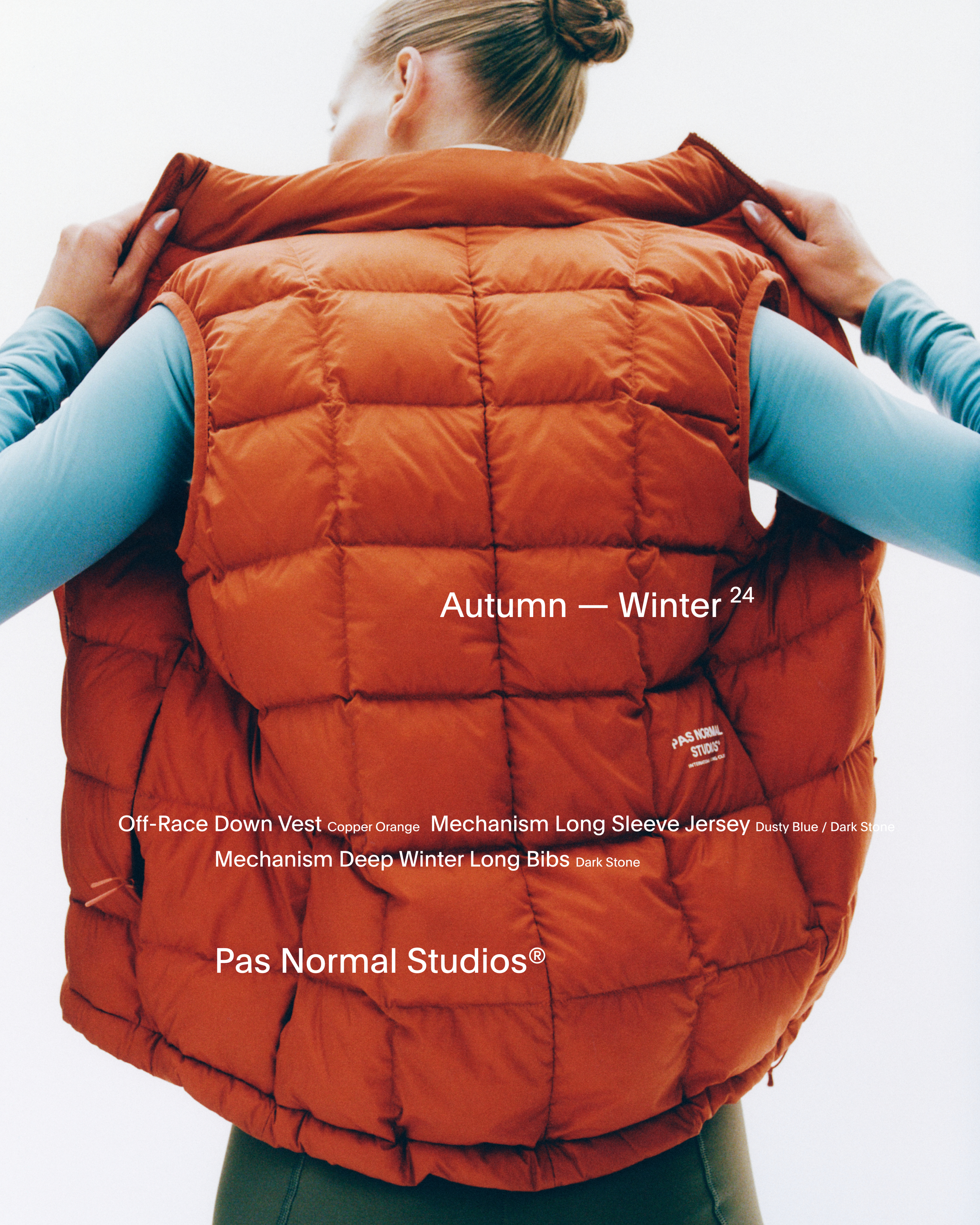 Model wearing orange Off-Race Down Vest with quilted pattern, back view