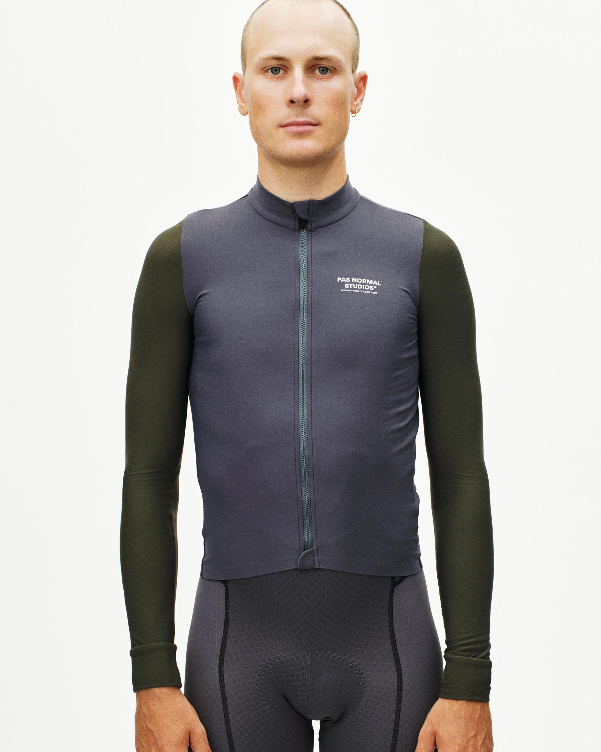 Grey Mechanism long sleeve cycling jersey on model with olive sleeves and white chest logo