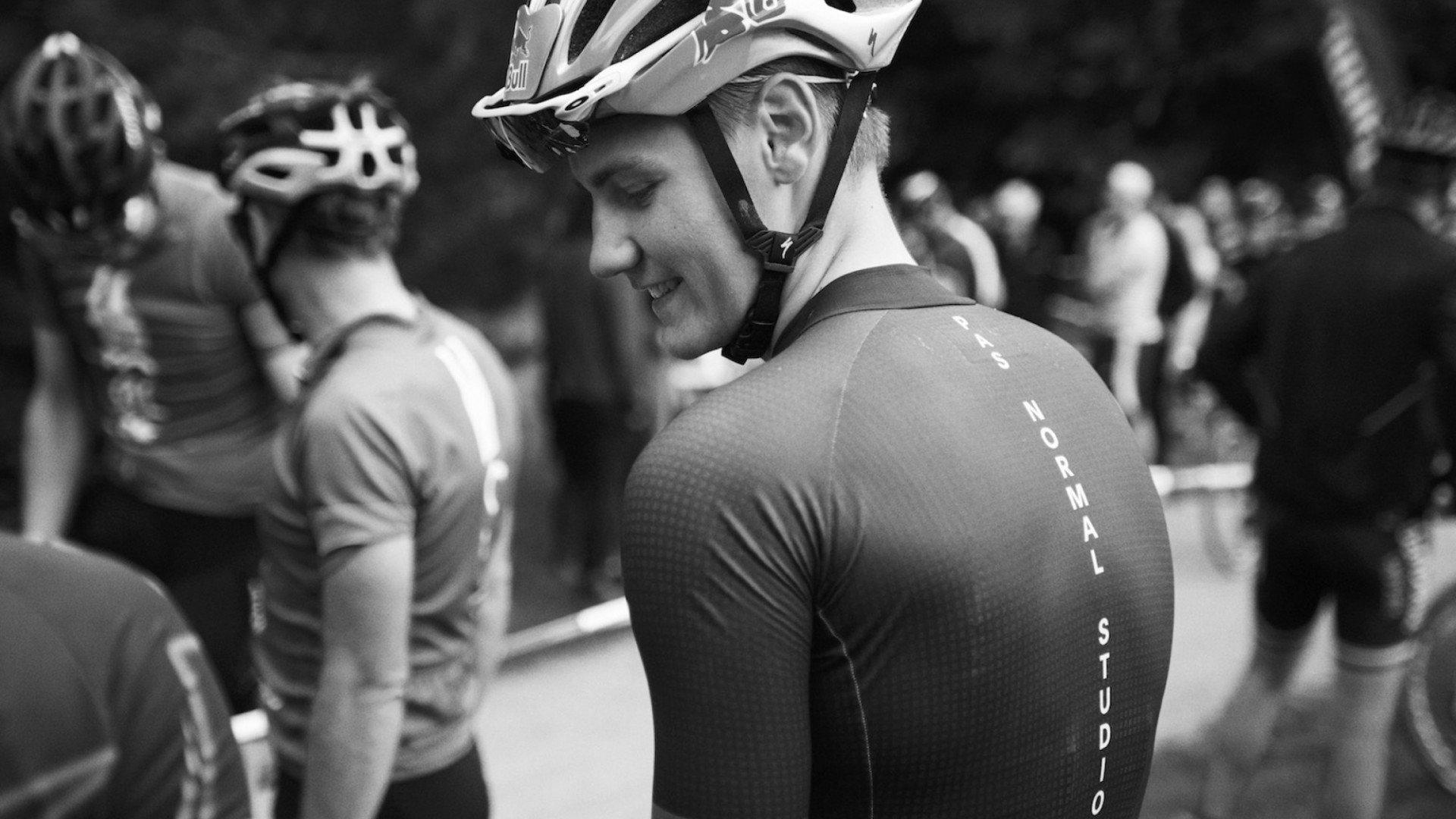 Model wearing cycling jersey with vertical text down the sleeve, black and white photo