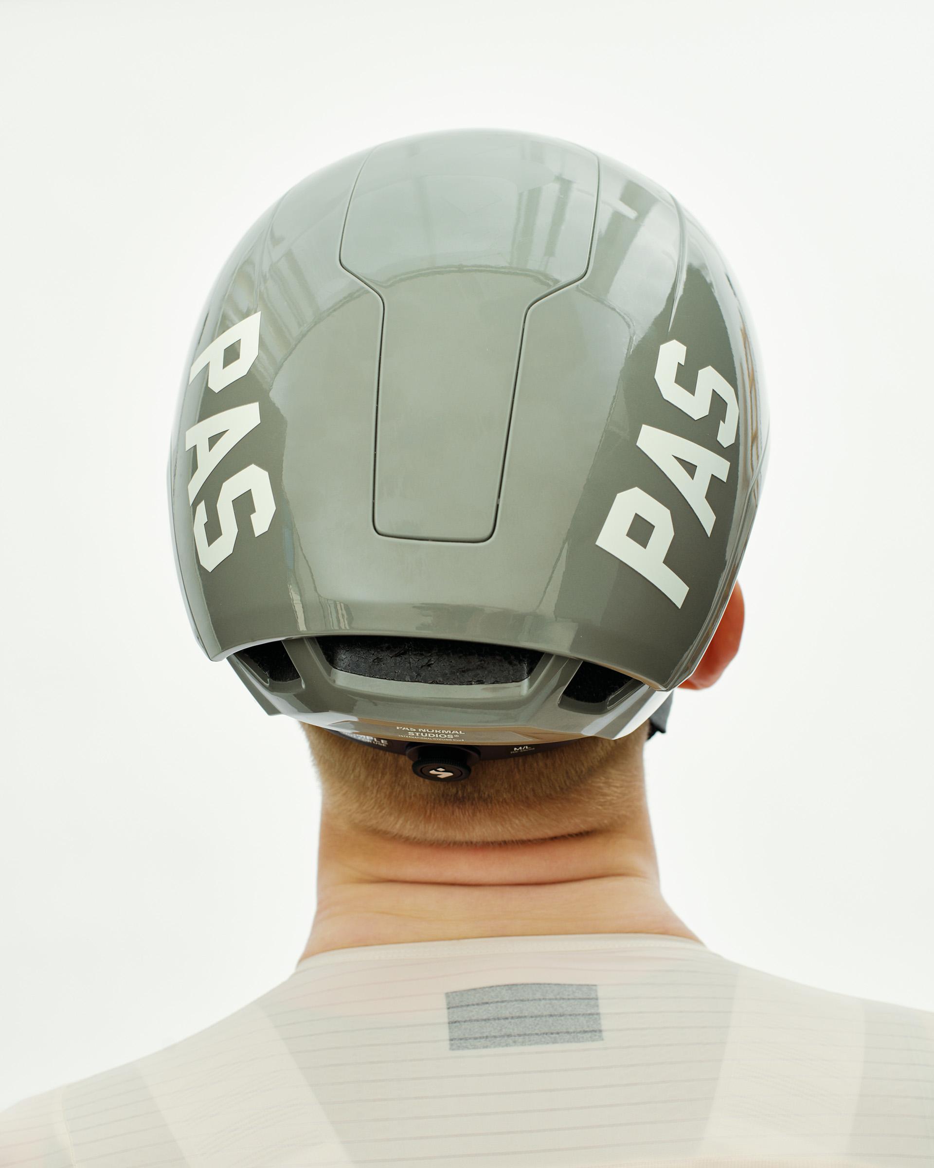 Grey PAS Tucker III 2Vi MIPS cycling helmet, rear view on model with white PAS branding