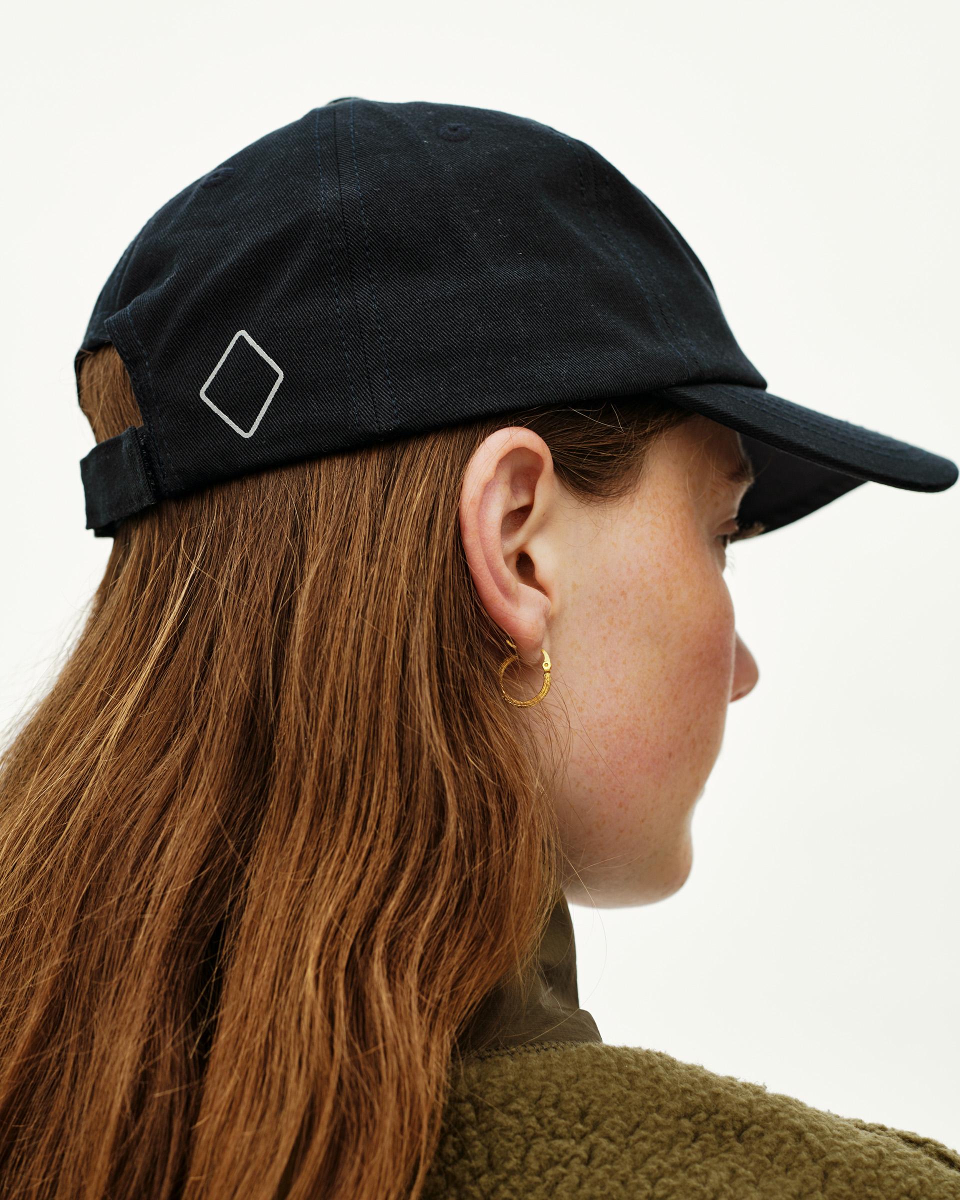 Black Off-Race Cotton Cap on model, side view with diamond logo embroidery on side panel