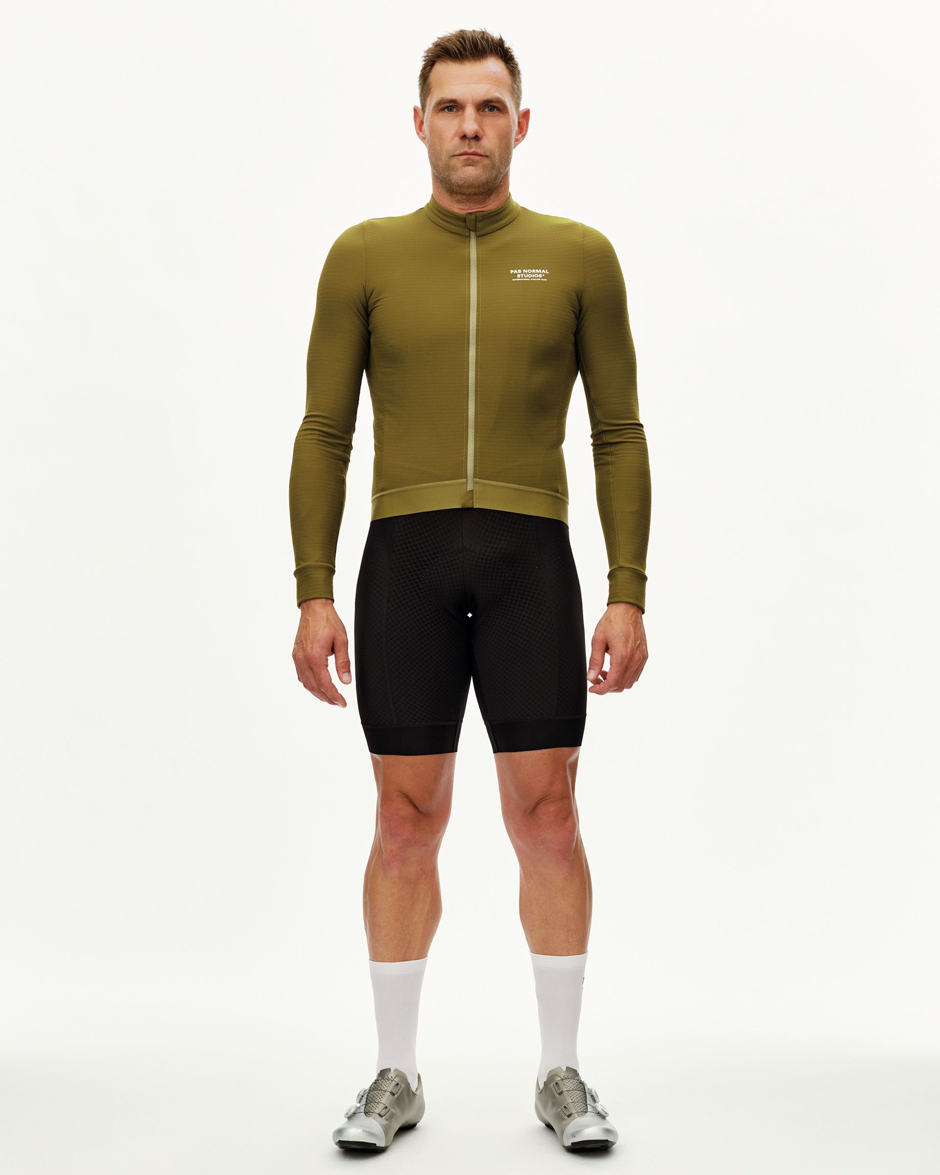 Khaki Green Essential long sleeve cycling jersey on model, front view with chest logo and tone-on-tone zip