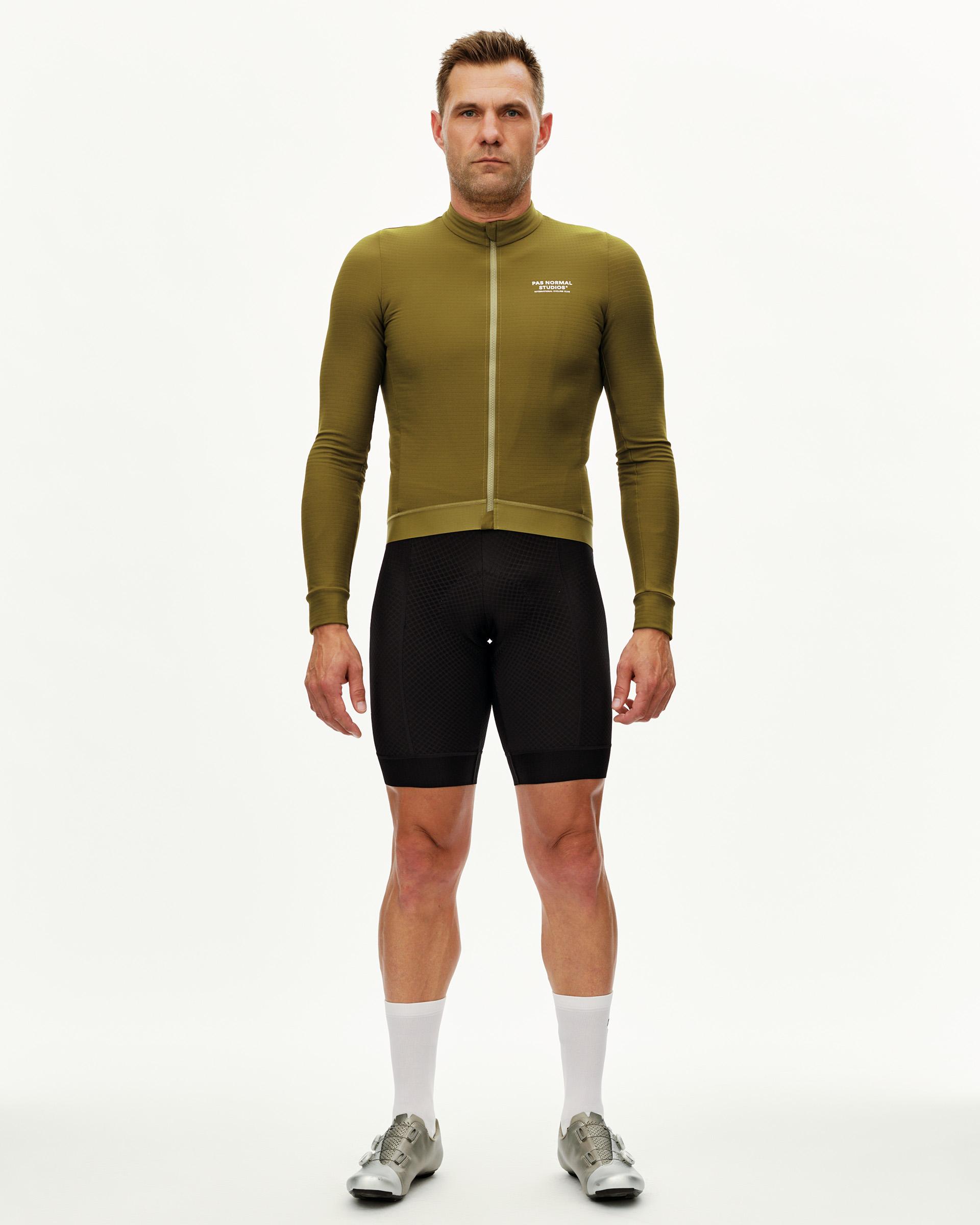 Khaki Green Essential long sleeve cycling jersey on model, front view with chest logo and tone-on-tone zip