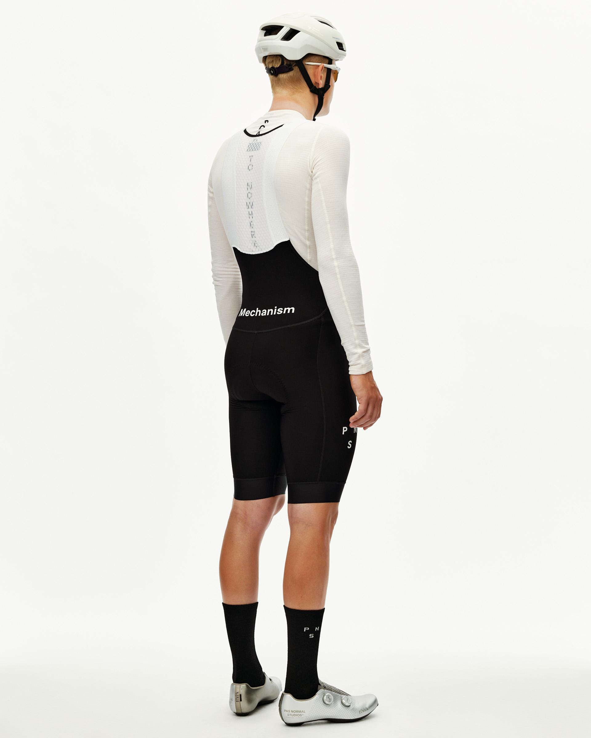 Black Mechanism Thermal cycling bibs on model, rear view with white logo waistband