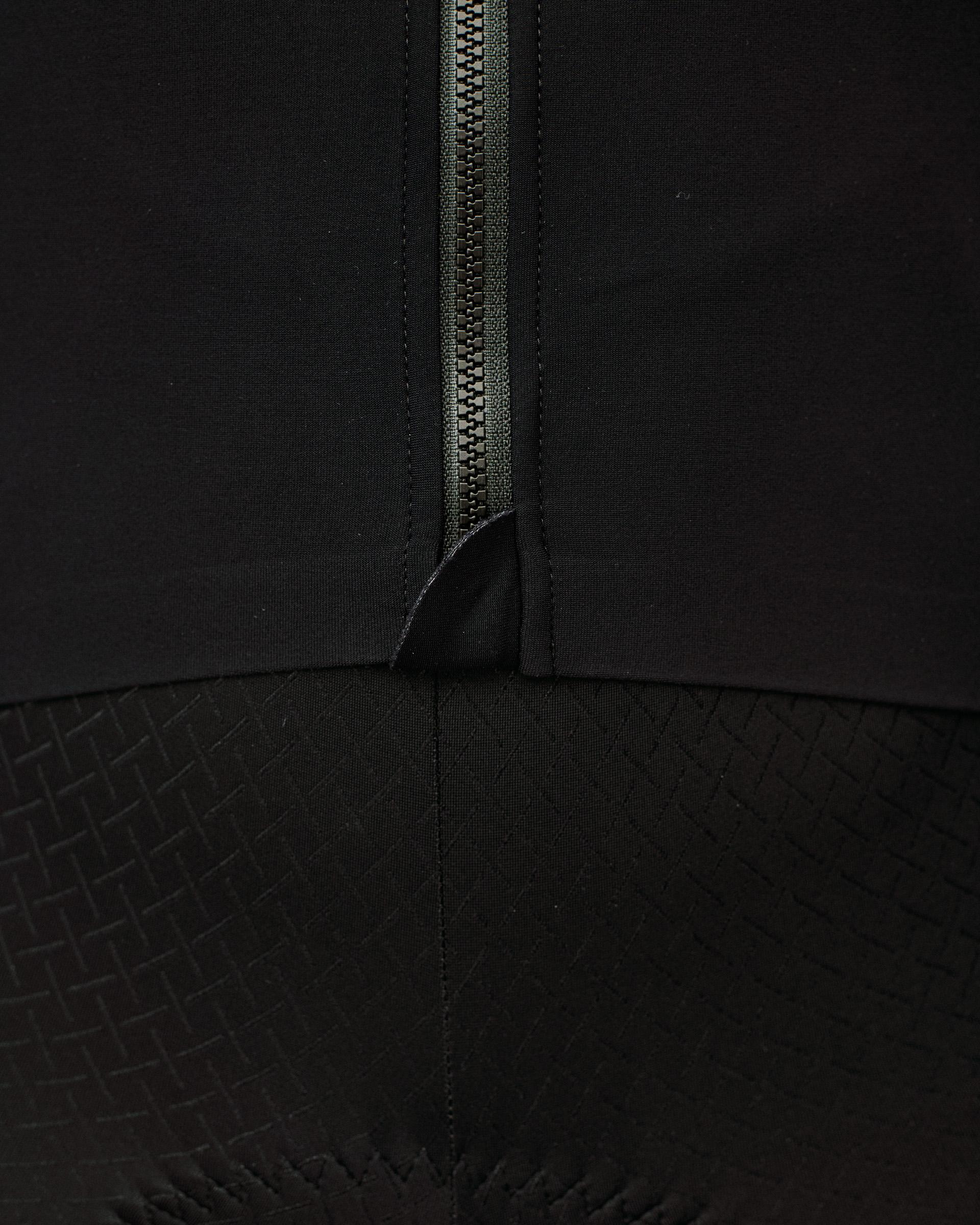 Black Mechanism long sleeve cycling jersey, detail view of front zip and textured lower panel