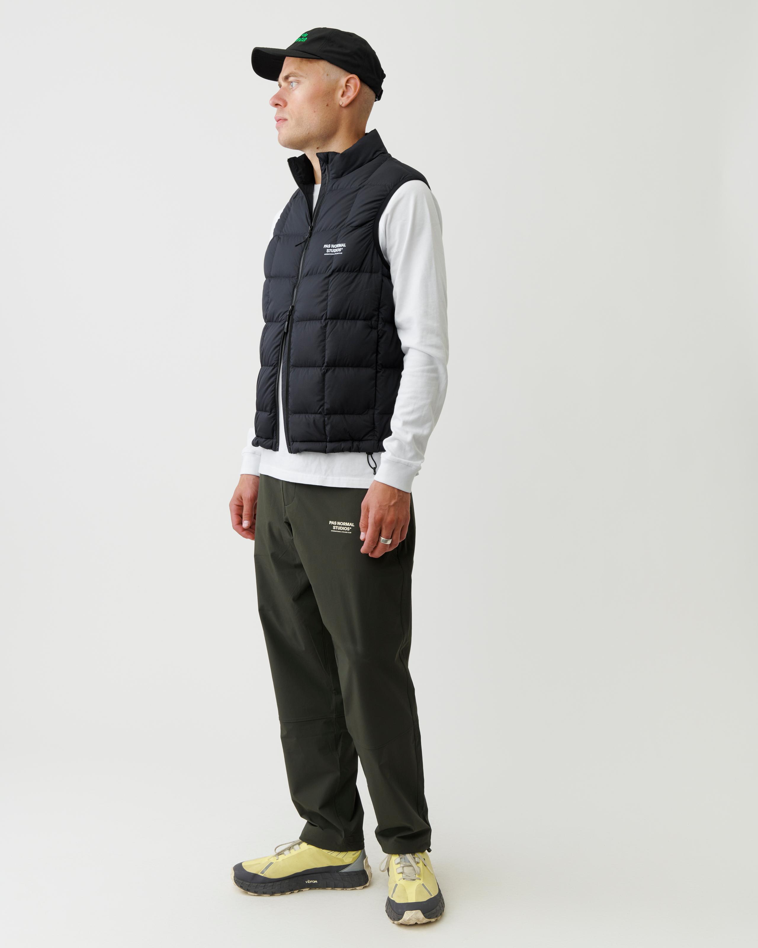 Black Off-Race Down Vest on model, three-quarter front view with quilted panels and chest logo
