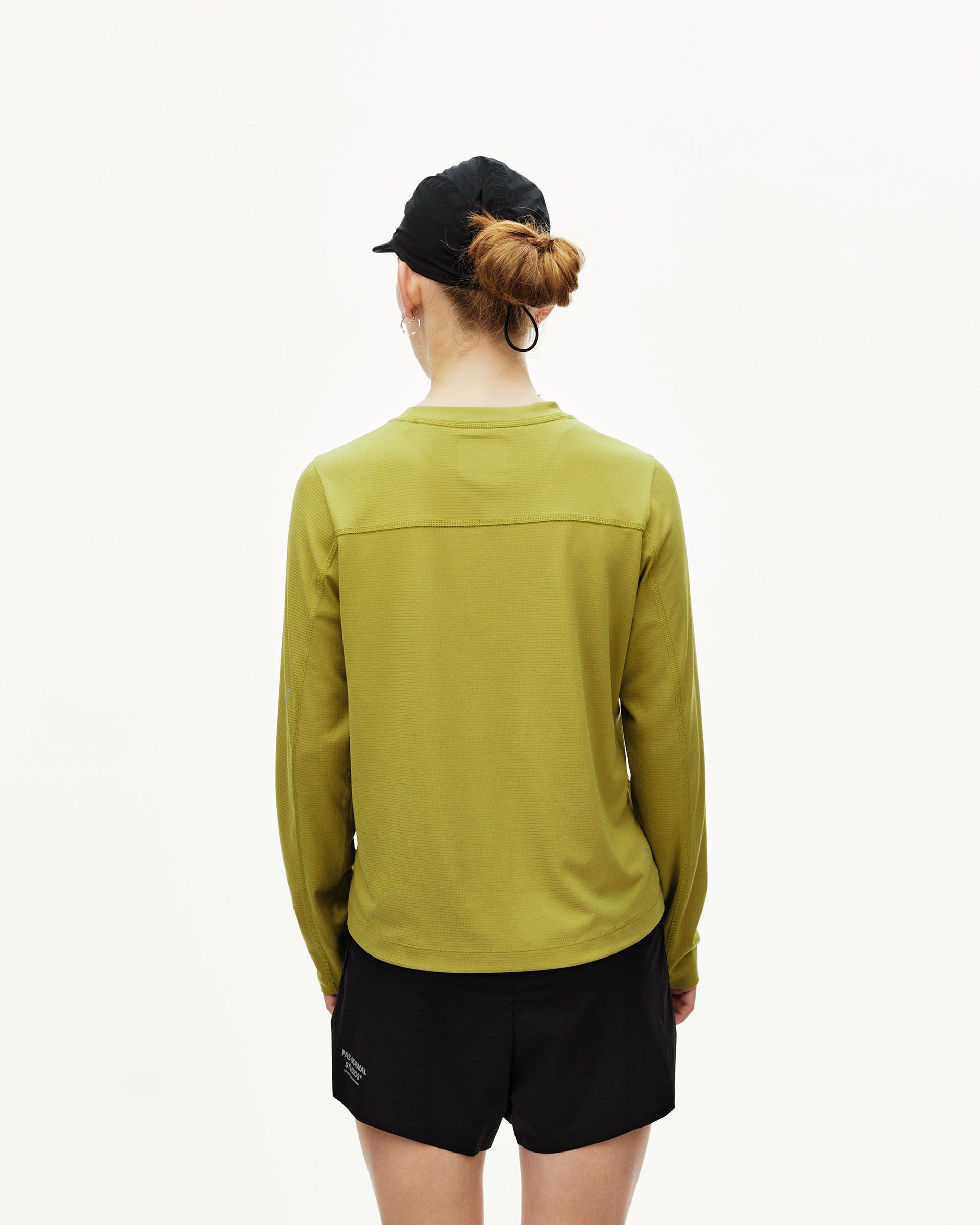 Dark Lime green Balance long sleeve T-shirt on model, rear view with textured shoulder panel